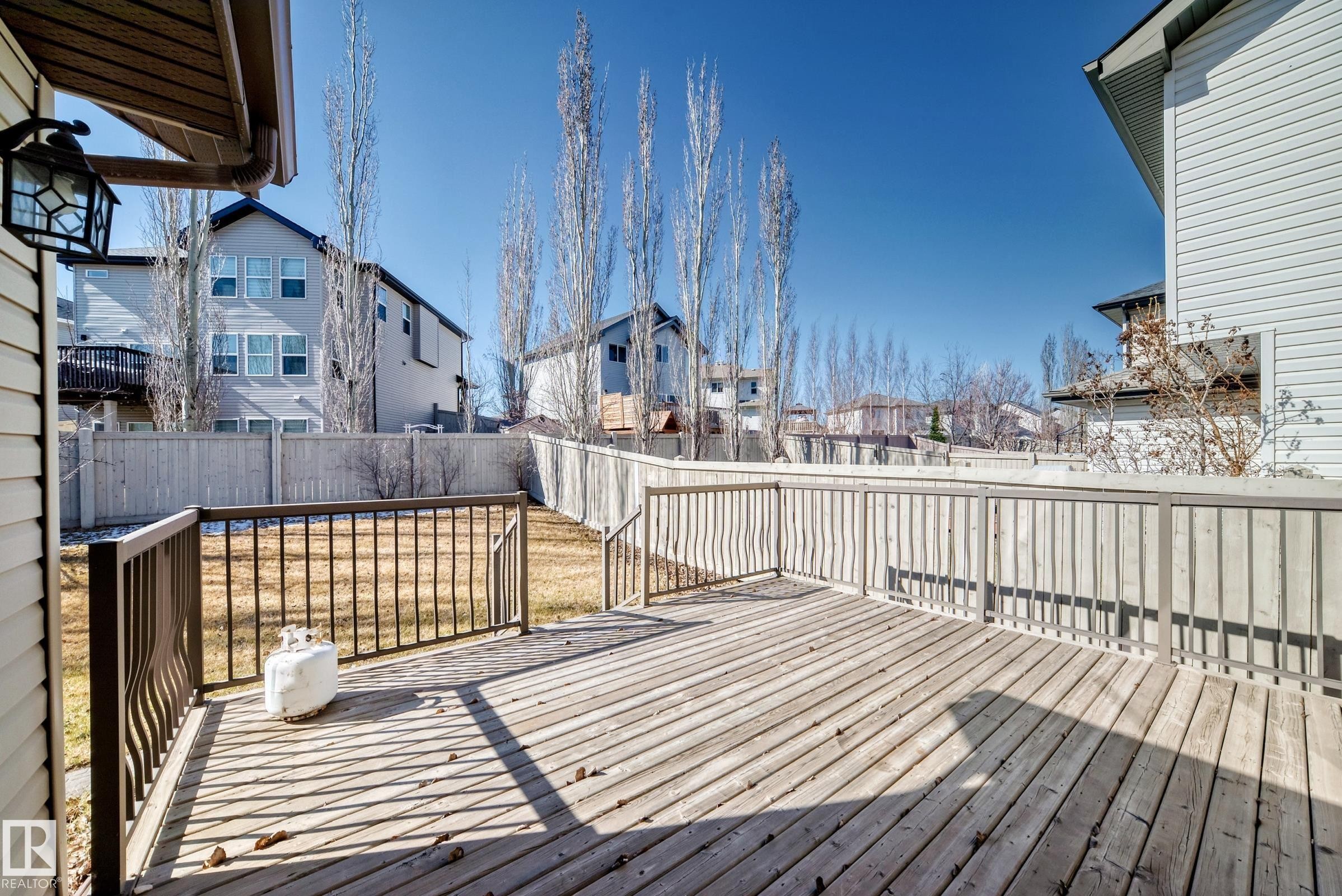 Spacious wood-finish deck with metal railings - 6723 19 Avenue, Edmonton, AB - Outdoor With Deck Patio Veranda With Exterior