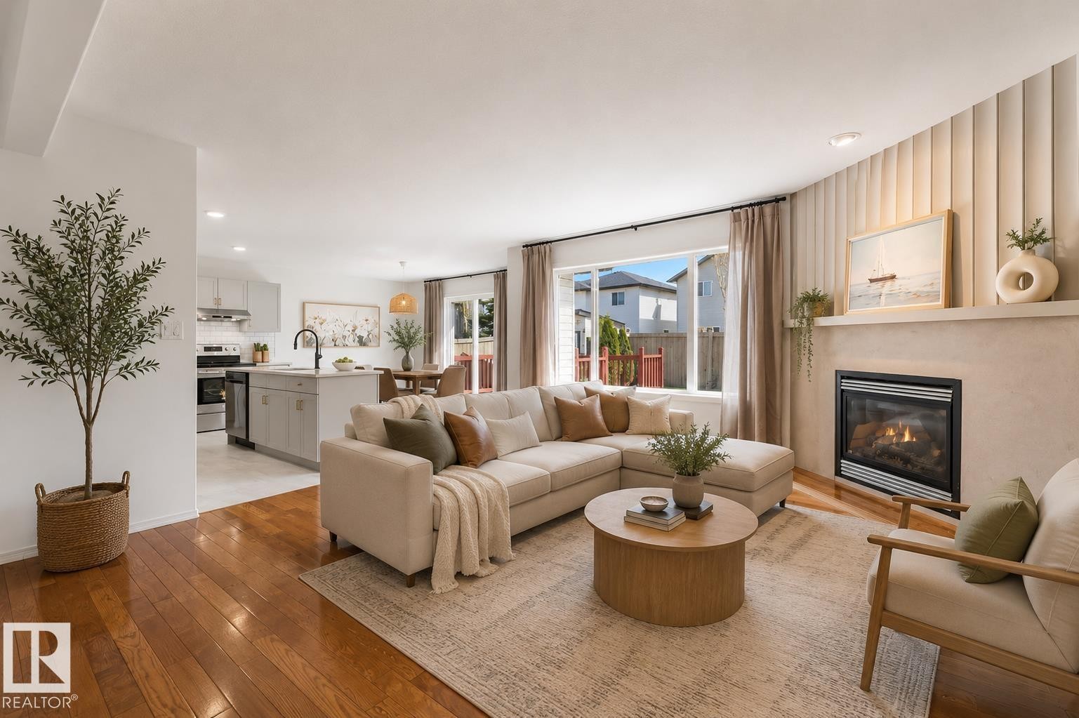 Open-concept living area featuring rich hardwood flooring, a contemporary fireplace with a mantle, and large windows - 326 Silver Berry Road, Edmonton, AB - Indoor Photo Showing Living Room With Fireplace