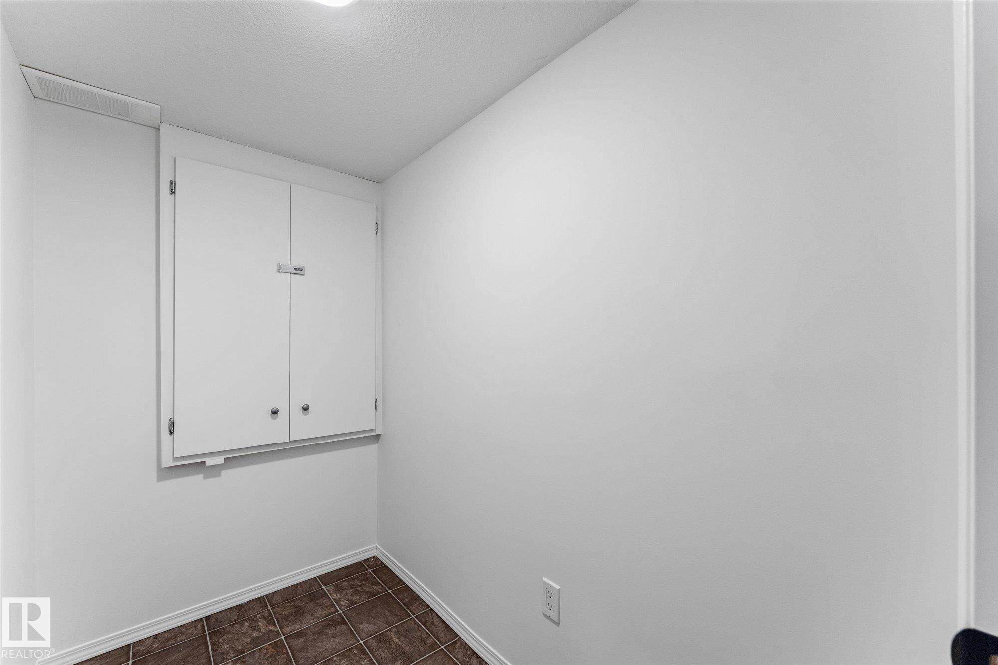 White wall-mounted cabinetry with two doors, finished with neutral hardware - 326 Silver Berry Road, Edmonton, AB - Indoor Photo Showing Other Room