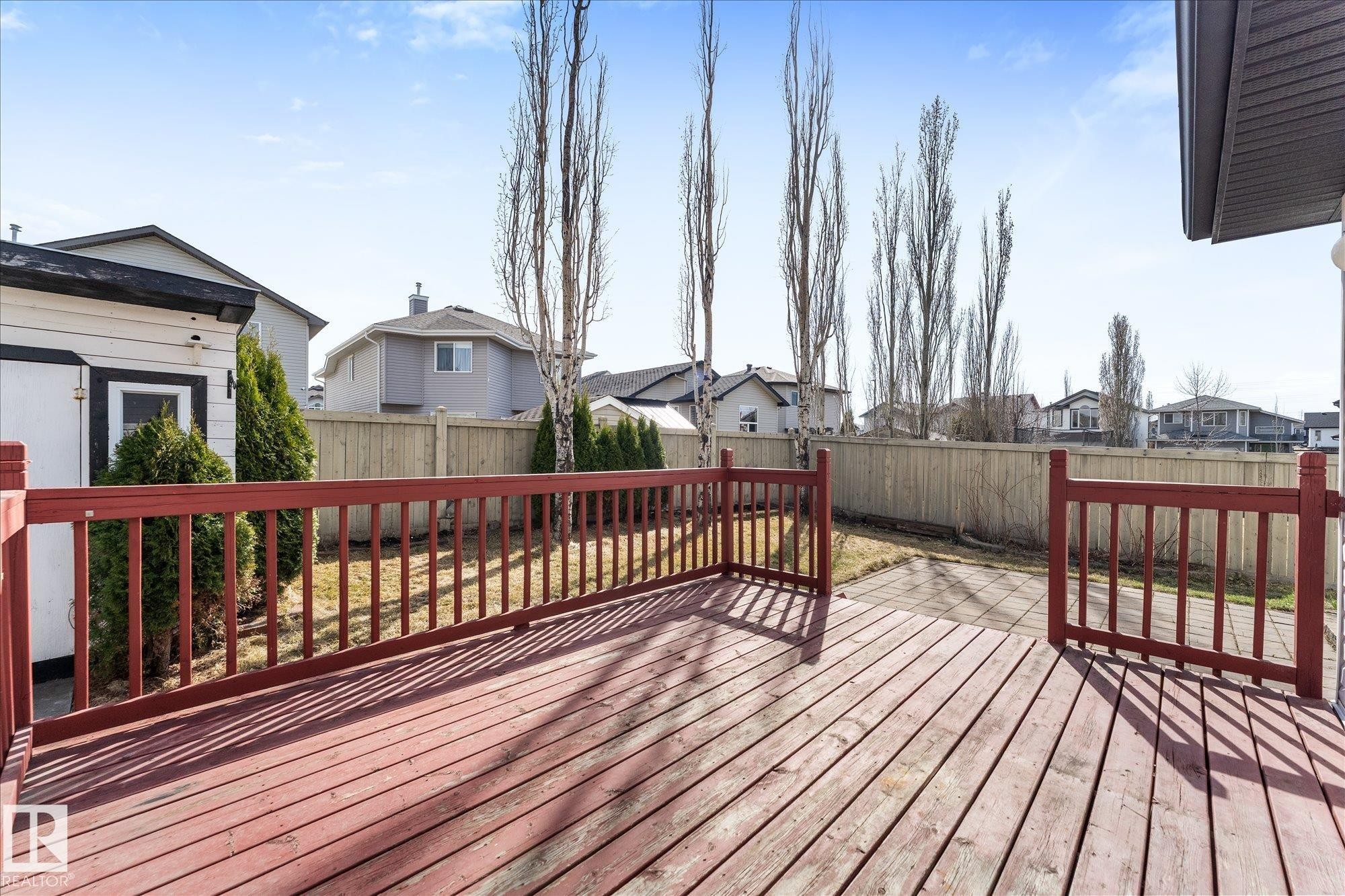 Spacious wood-finish deck with red railings - 326 Silver Berry Road, Edmonton, AB - Outdoor With Deck Patio Veranda With Exterior