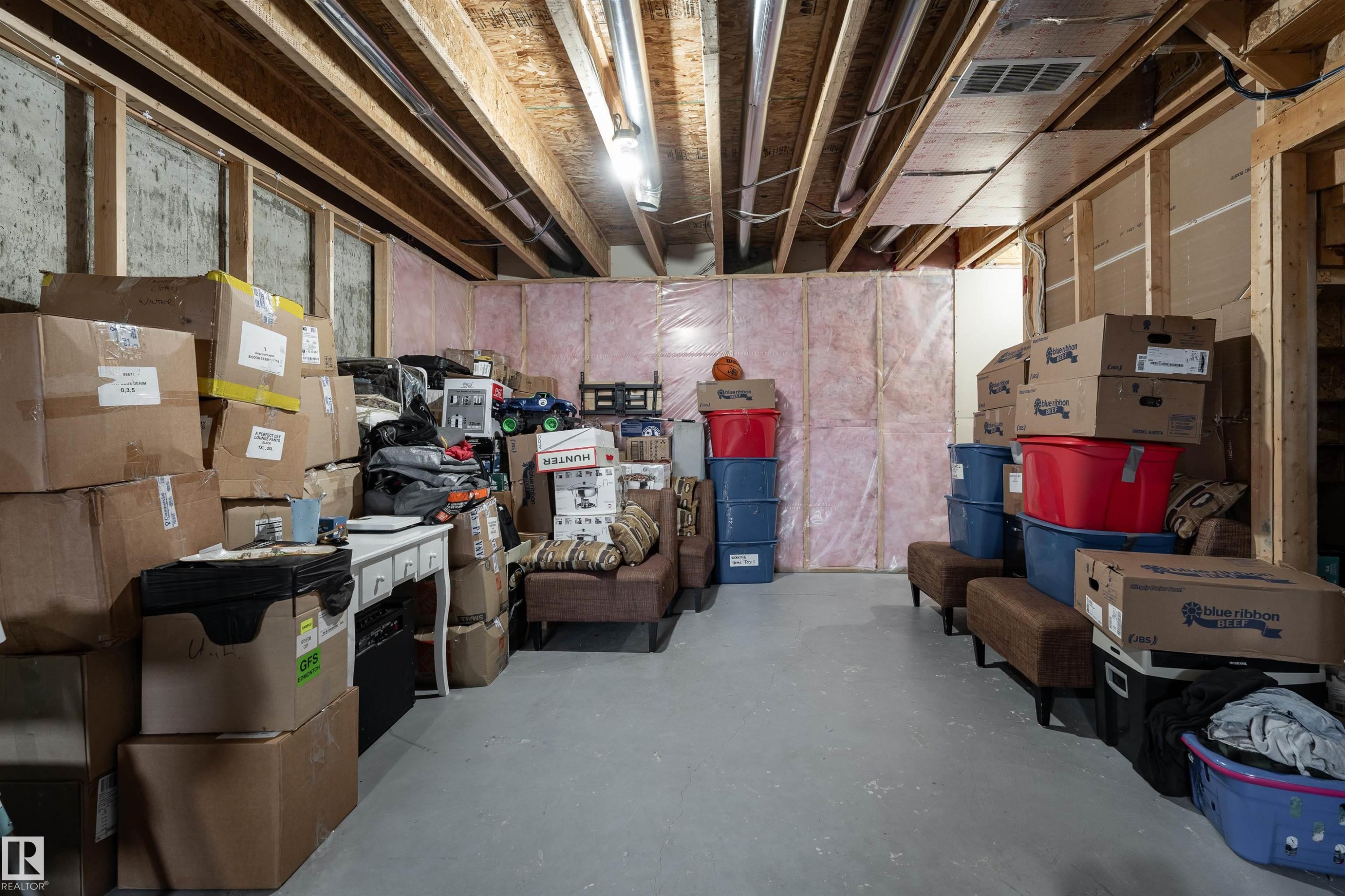 Unfinished basement featuring exposed wood joists and concrete flooring - 15 5203 149 Avenue, Edmonton, AB - Indoor Photo Showing Basement