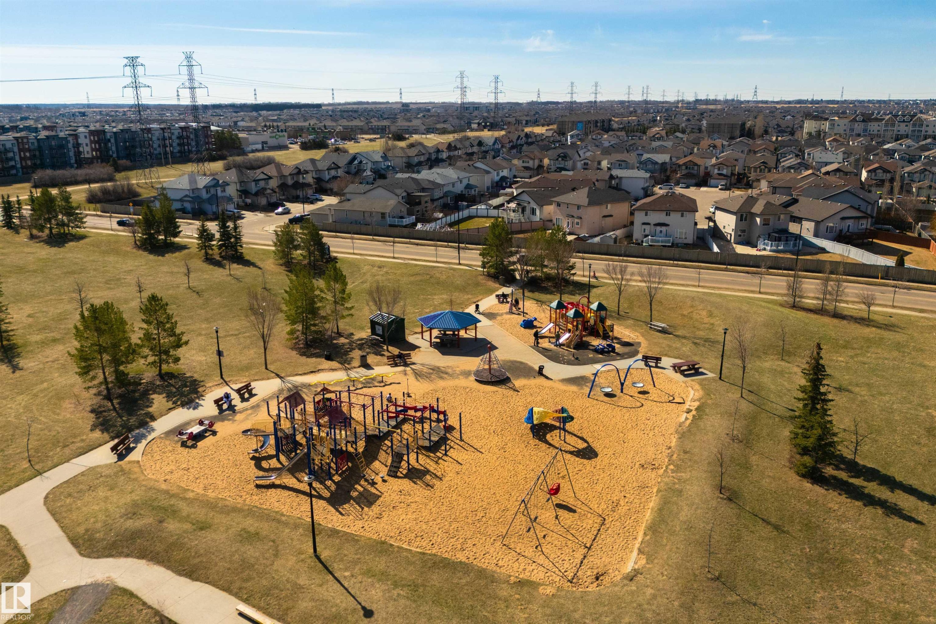 Expansive community park featuring multiple play structures, a covered picnic area, and surrounding green space - 2923 30 Street, Edmonton, AB - Outdoor With View