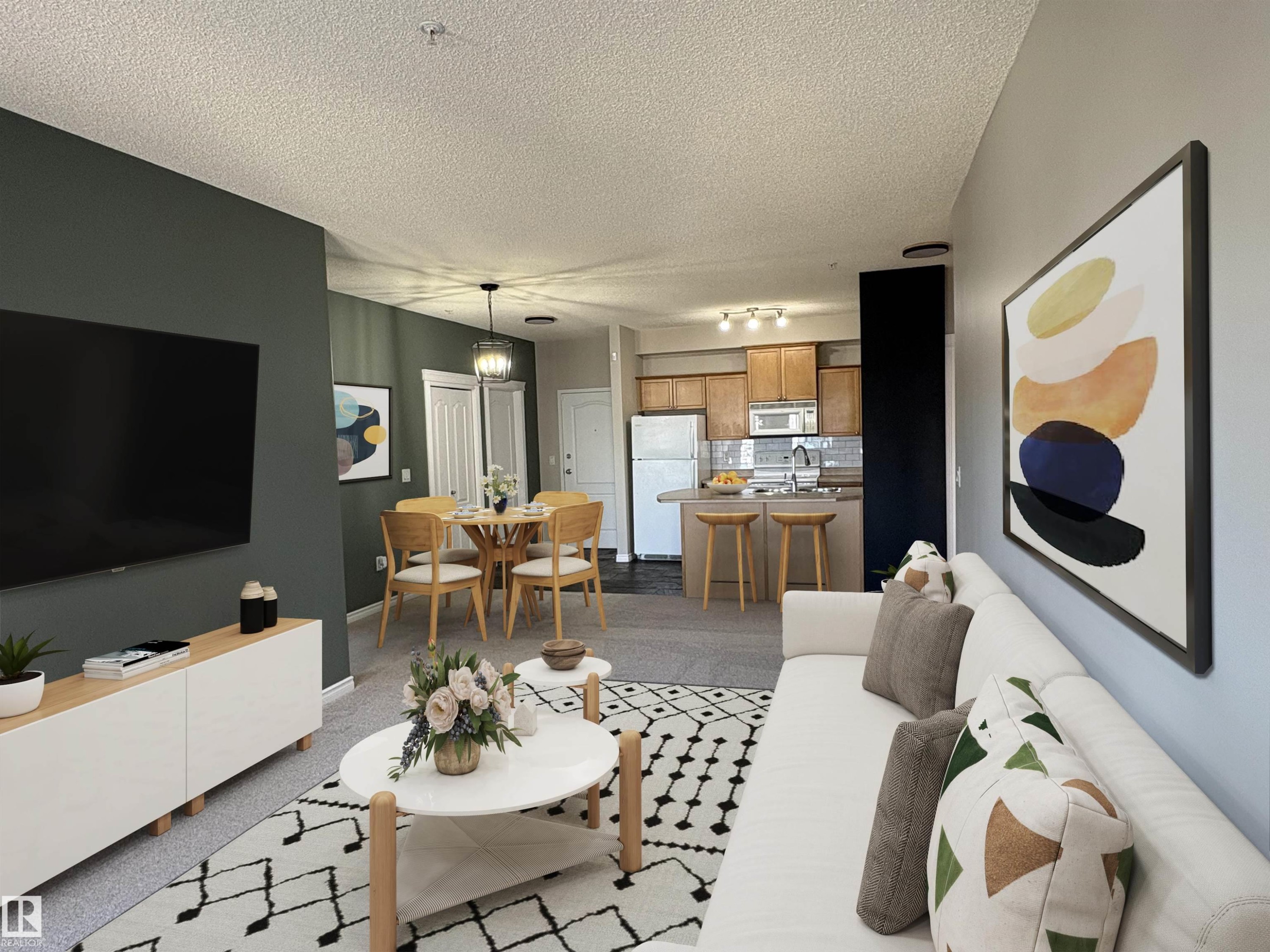 Open-concept living space with carpeted flooring, a dedicated dining area featuring a pendant light fixture, and a kitchen with wood cabinetry and stainless steel appliances - 224 16807 100 Avenue, Edmonton, AB - Indoor Photo Showing Living Room