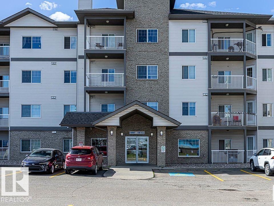 Multi-story residential building featuring a stone and siding exterior - 224 16807 100 Avenue, Edmonton, AB - Outdoor With Balcony With Facade