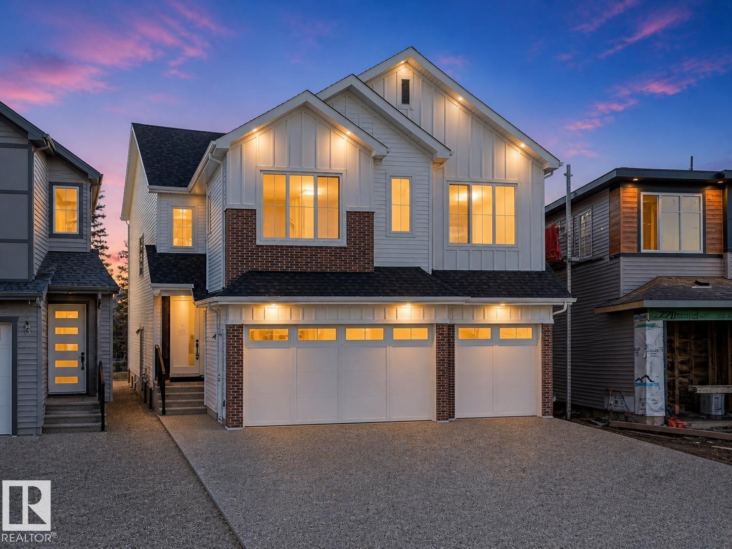 Contemporary exterior featuring white vertical siding, brick accents, and a dark shingle roof - 2070 Collip Crescent Sw, Edmonton, AB - Outdoor With Facade
