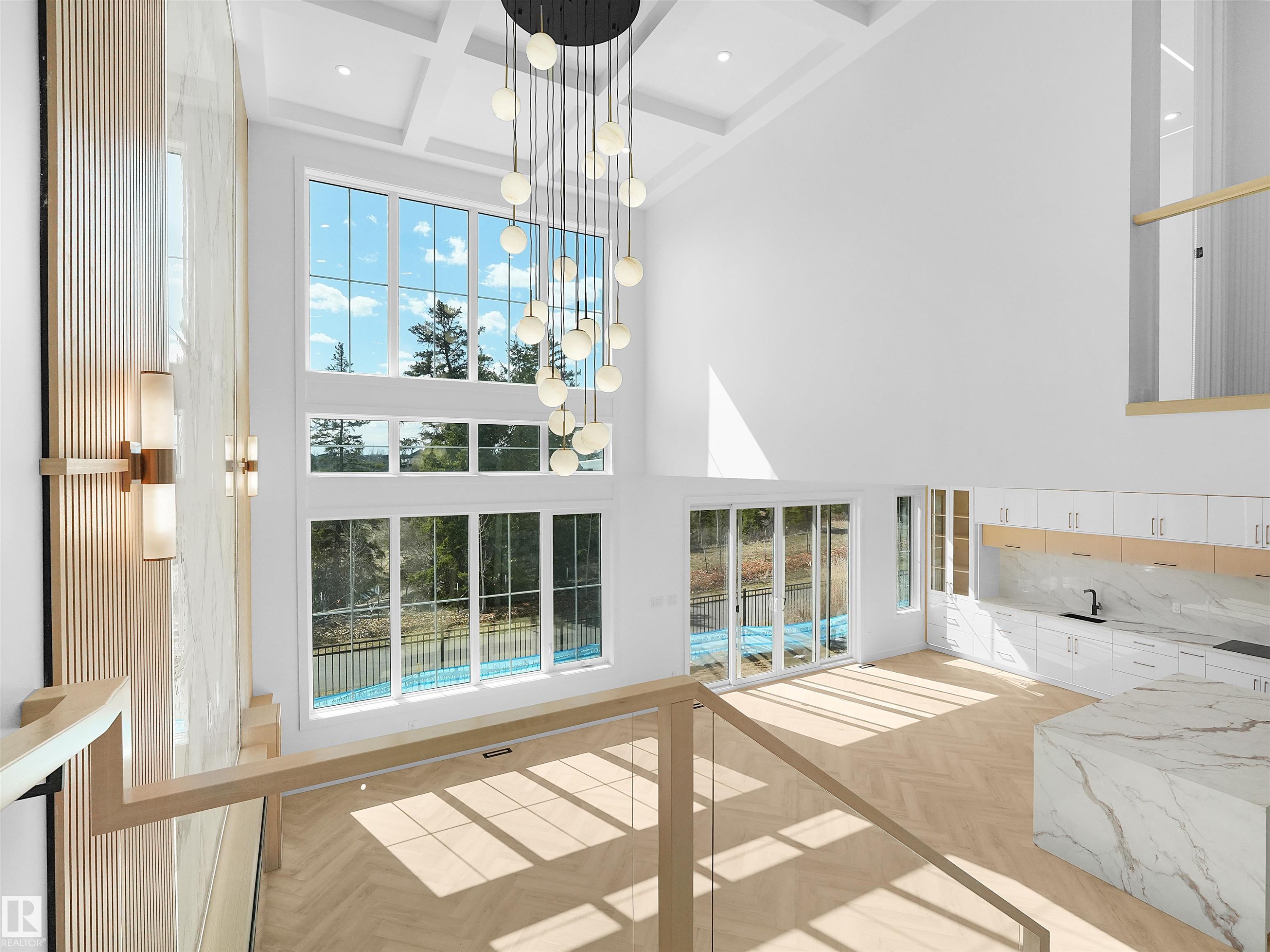 Two-story living area with coffered ceiling and a multi-globe chandelier - 2070 Collip Crescent Sw, Edmonton, AB - Indoor Photo Showing Other Room