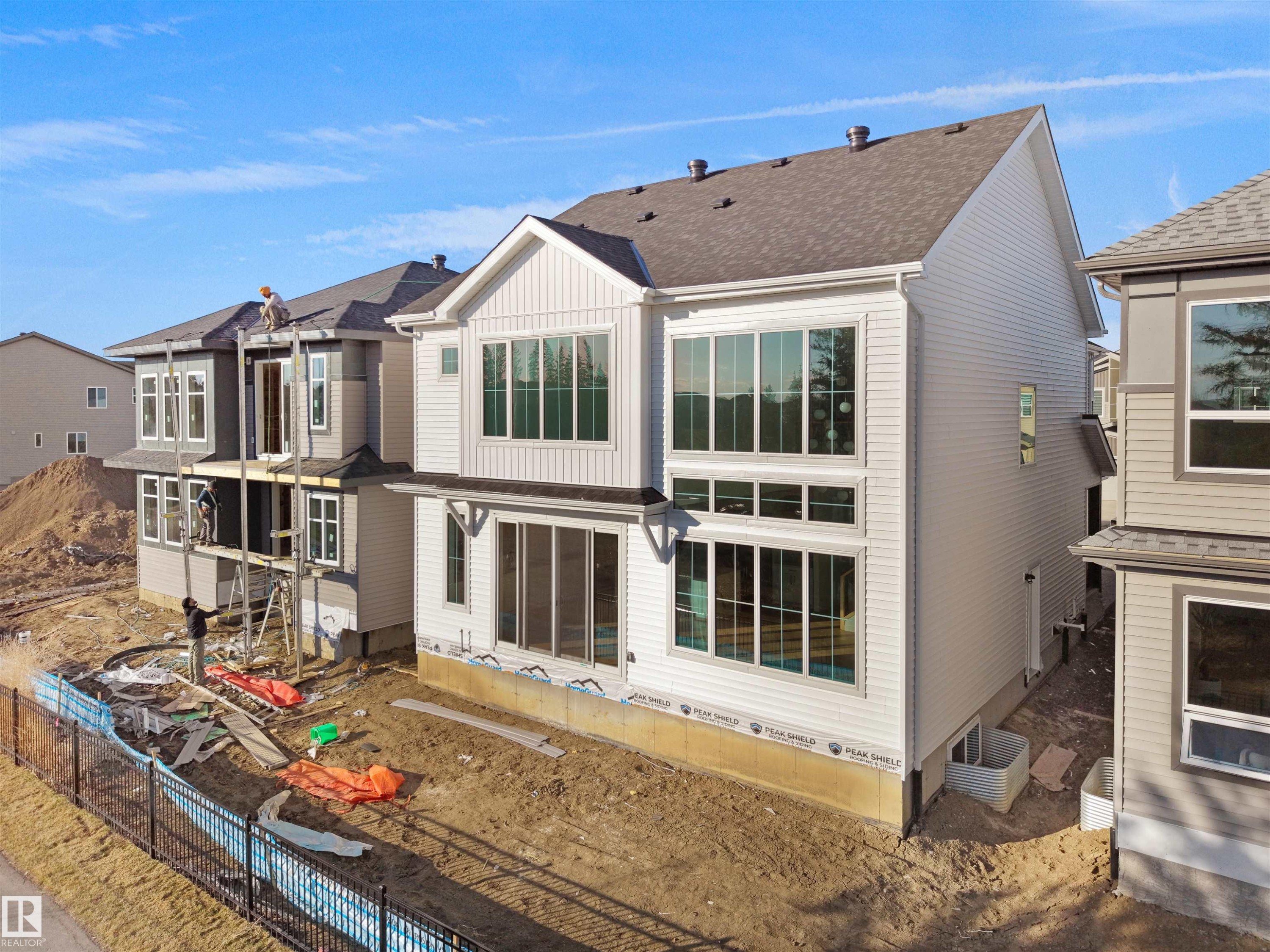 Contemporary multi-story residence featuring light-toned horizontal siding and a dark shingle roof - 2070 Collip Crescent Sw, Edmonton, AB - Outdoor
