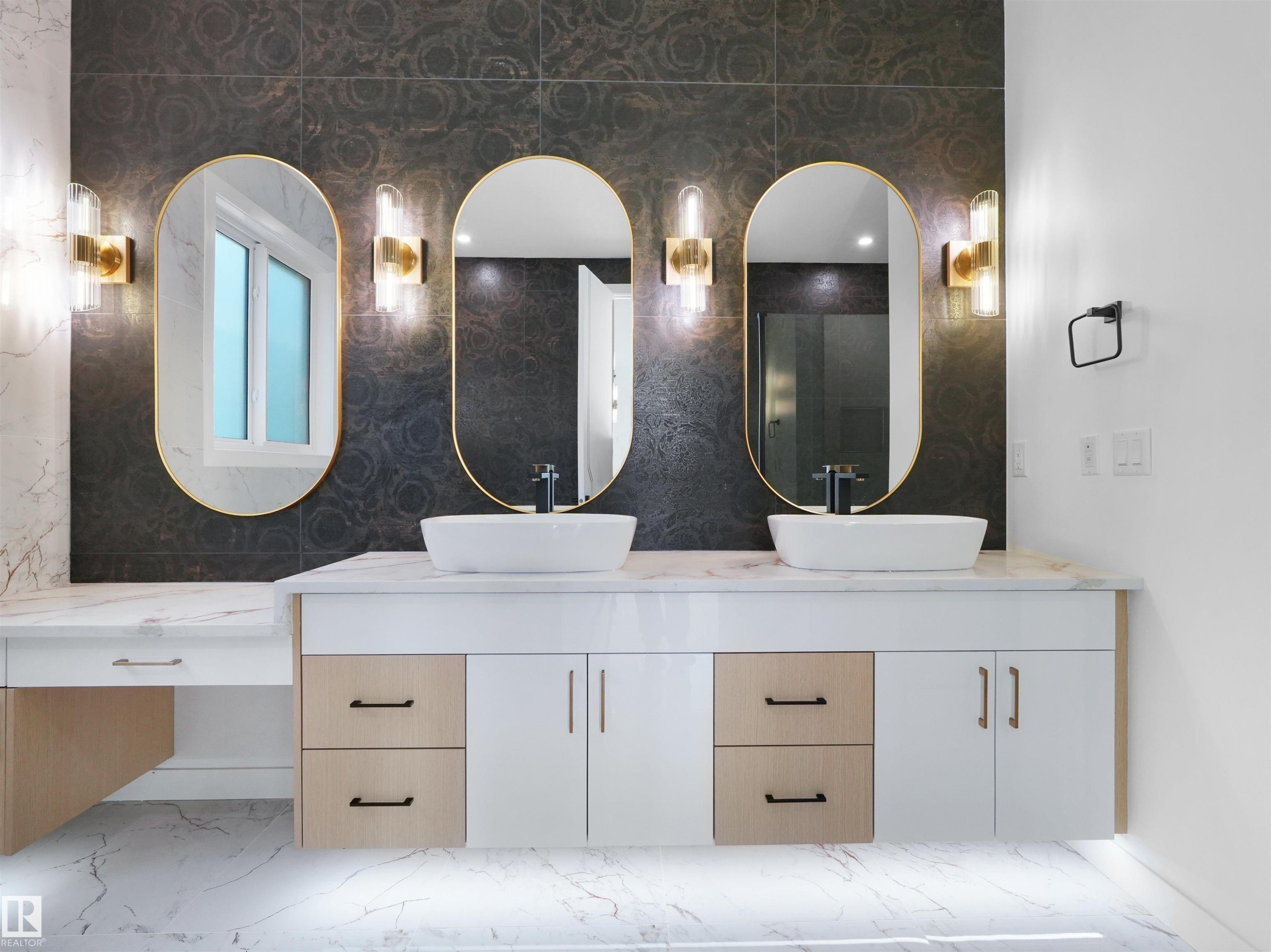 Dual vessel sinks set atop a floating vanity with a marble-finish countertop - 2070 Collip Crescent Sw, Edmonton, AB - Indoor Photo Showing Bathroom