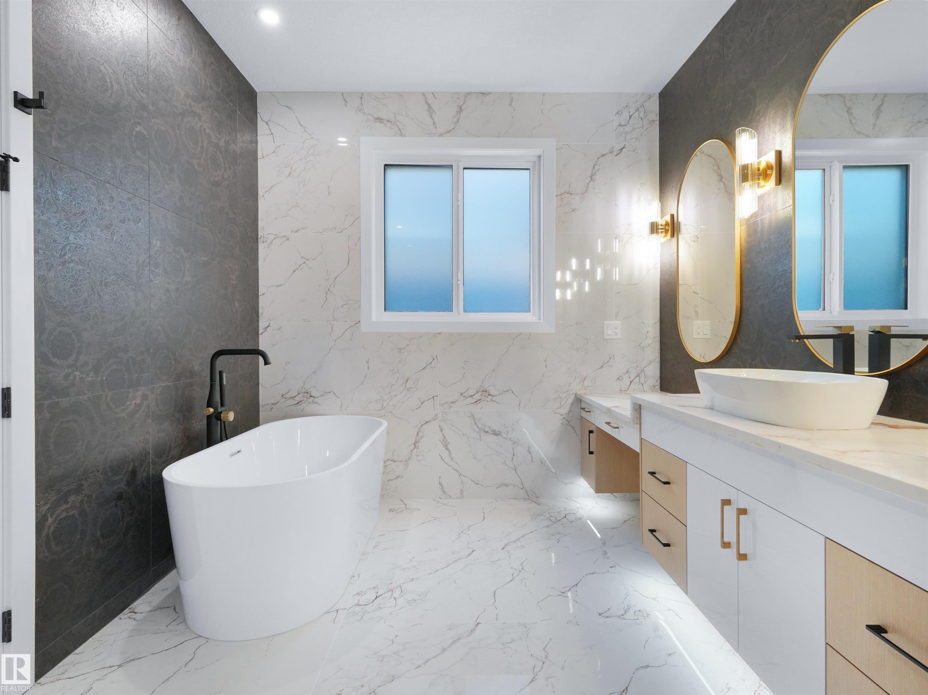 Freestanding soaking tub with a matte black floor-mounted faucet - 2070 Collip Crescent Sw, Edmonton, AB - Indoor Photo Showing Bathroom