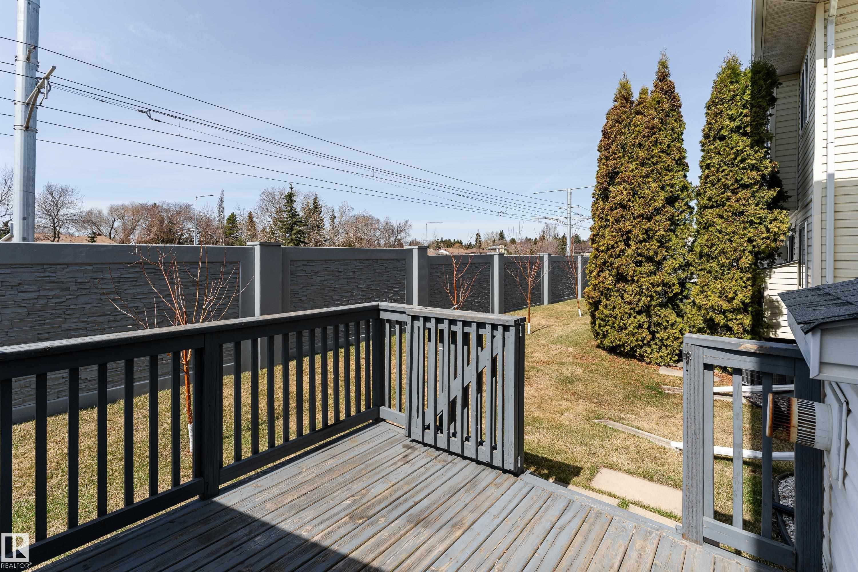 Wooden deck featuring dark grey railings - #63 1033 Youville Dr W Nw, Edmonton, AB - Outdoor With Deck Patio Veranda With Exterior