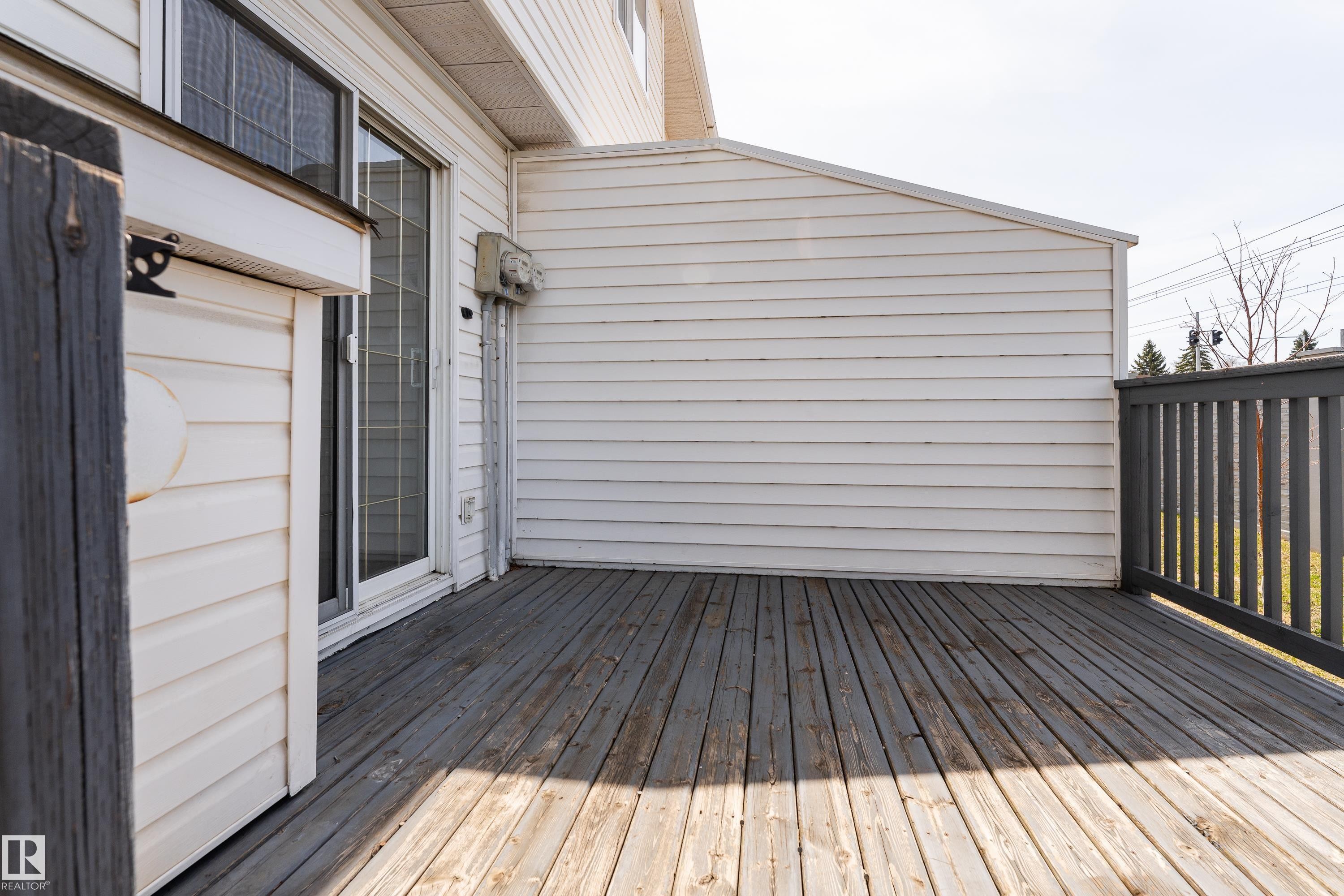 Wood-finish deck with a gray railing - #63 1033 Youville Dr W Nw, Edmonton, AB - Outdoor With Deck Patio Veranda With Exterior