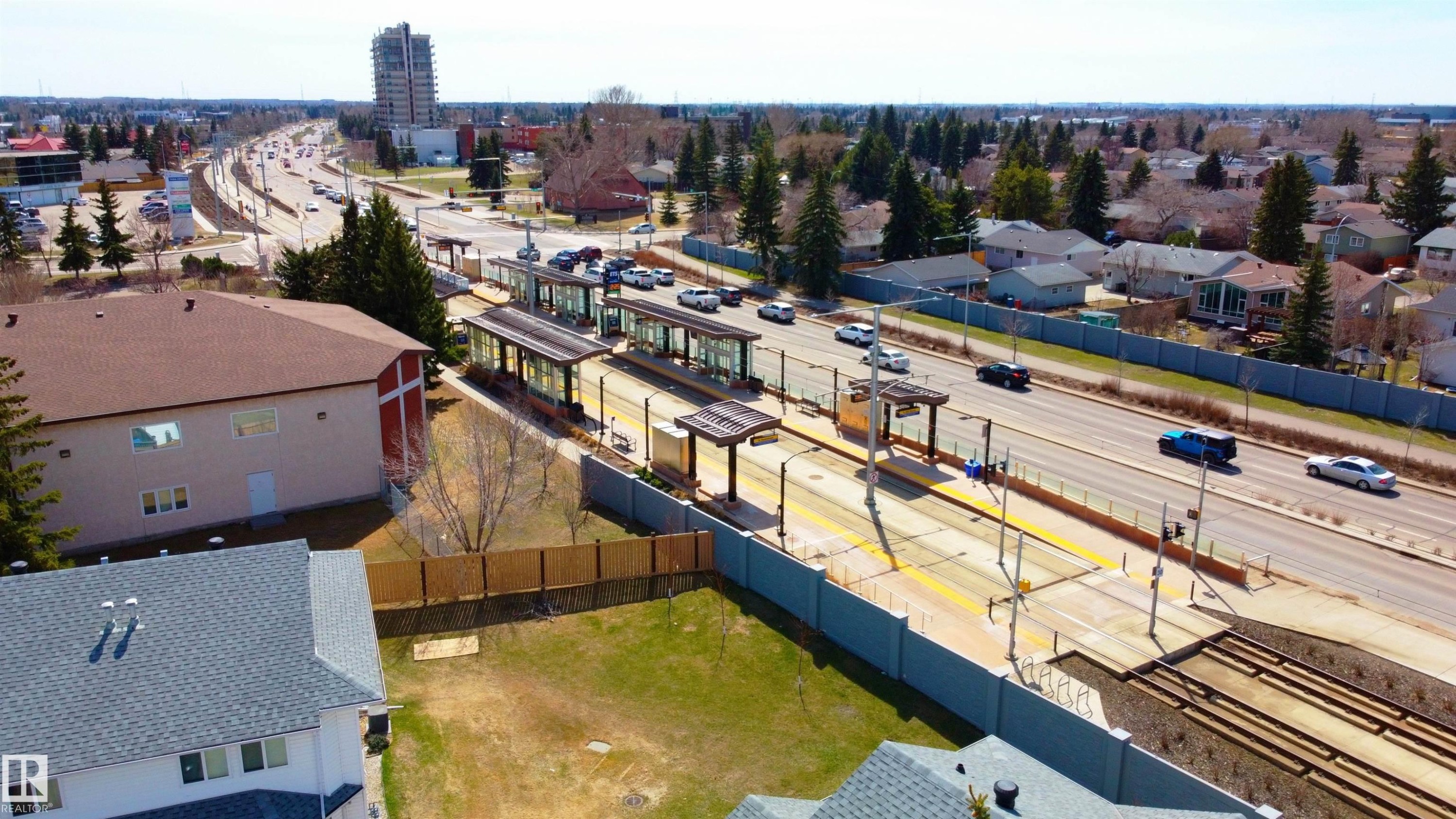 Transportation hub featuring a light rail transit station and a multi-lane roadway - #63 1033 Youville Dr W Nw, Edmonton, AB - Outdoor With View