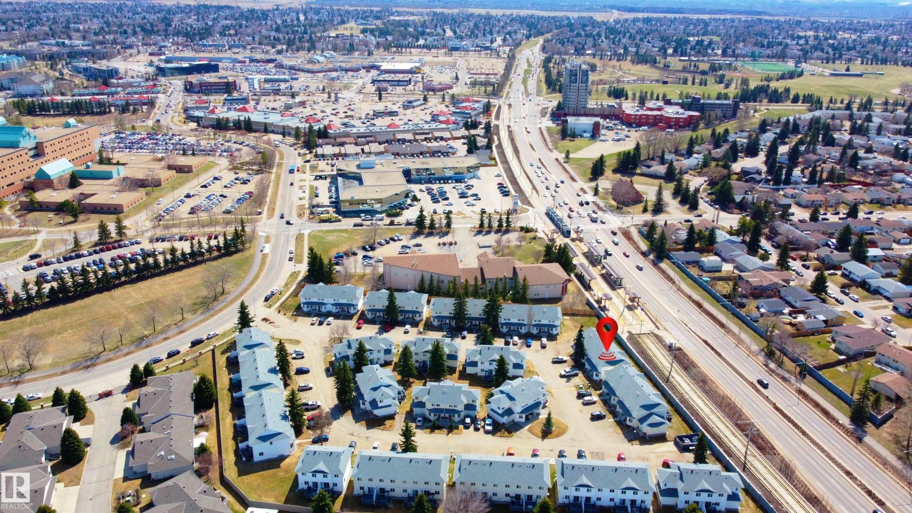 Aerial perspective showcasing a residential community with multi-lane thoroughfares - #63 1033 Youville Dr W Nw, Edmonton, AB - Outdoor With View