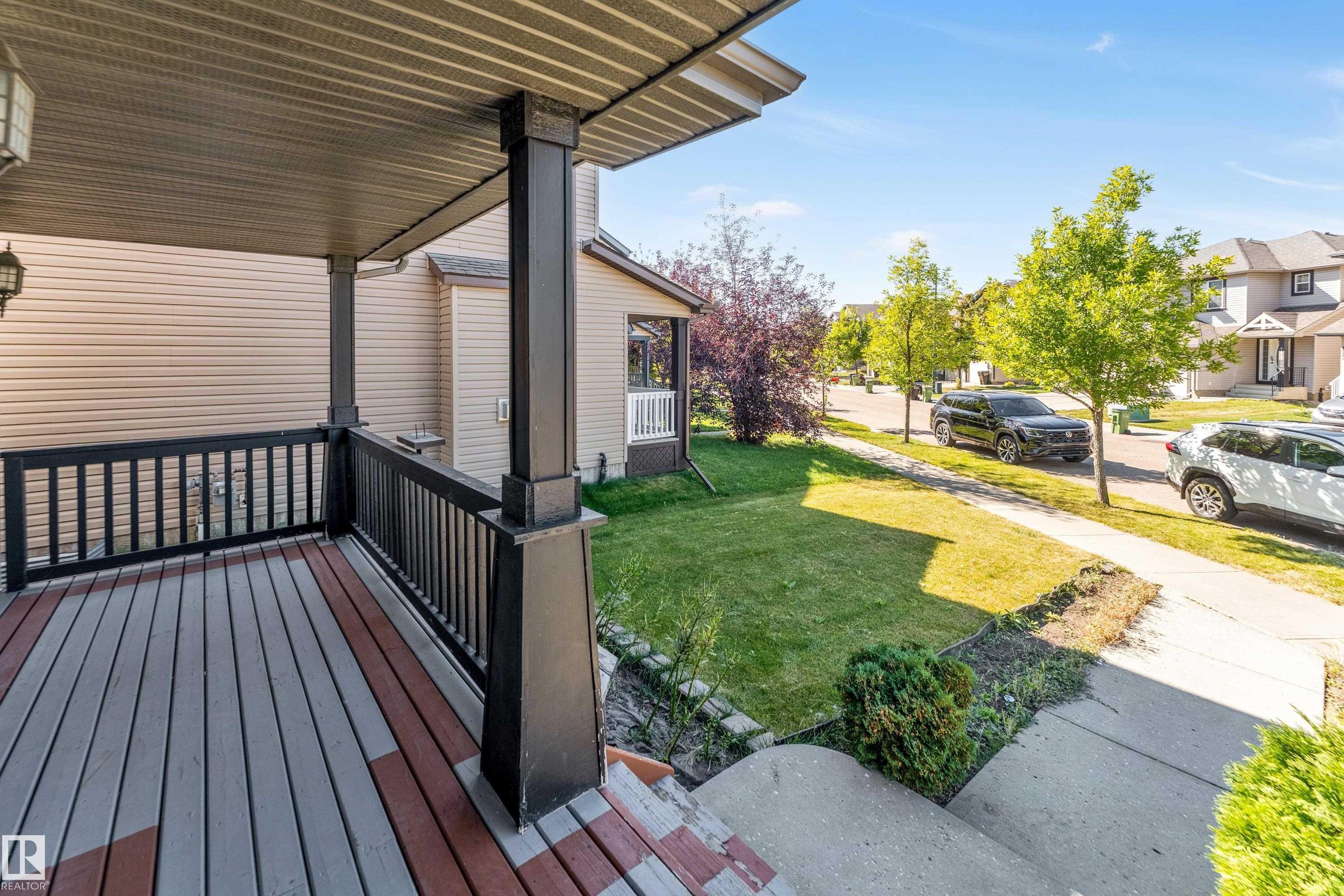 Covered porch with composite decking and black railings - 1921 119A Street, Edmonton, AB