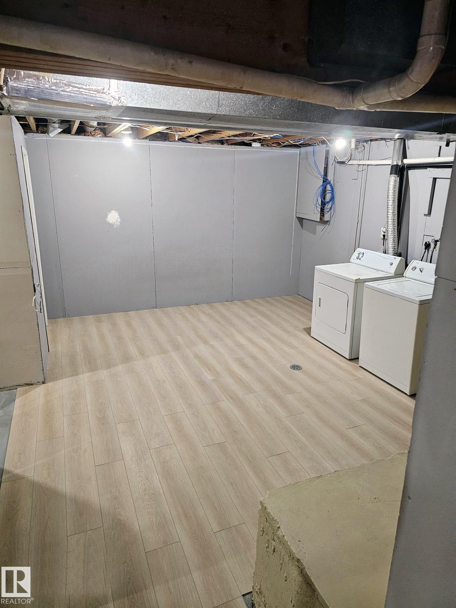 Utility space featuring light wood-finish flooring, exposed ceiling beams, and a floor drain - 20 Hunt Road, Edmonton, AB - Indoor Photo Showing Laundry Room