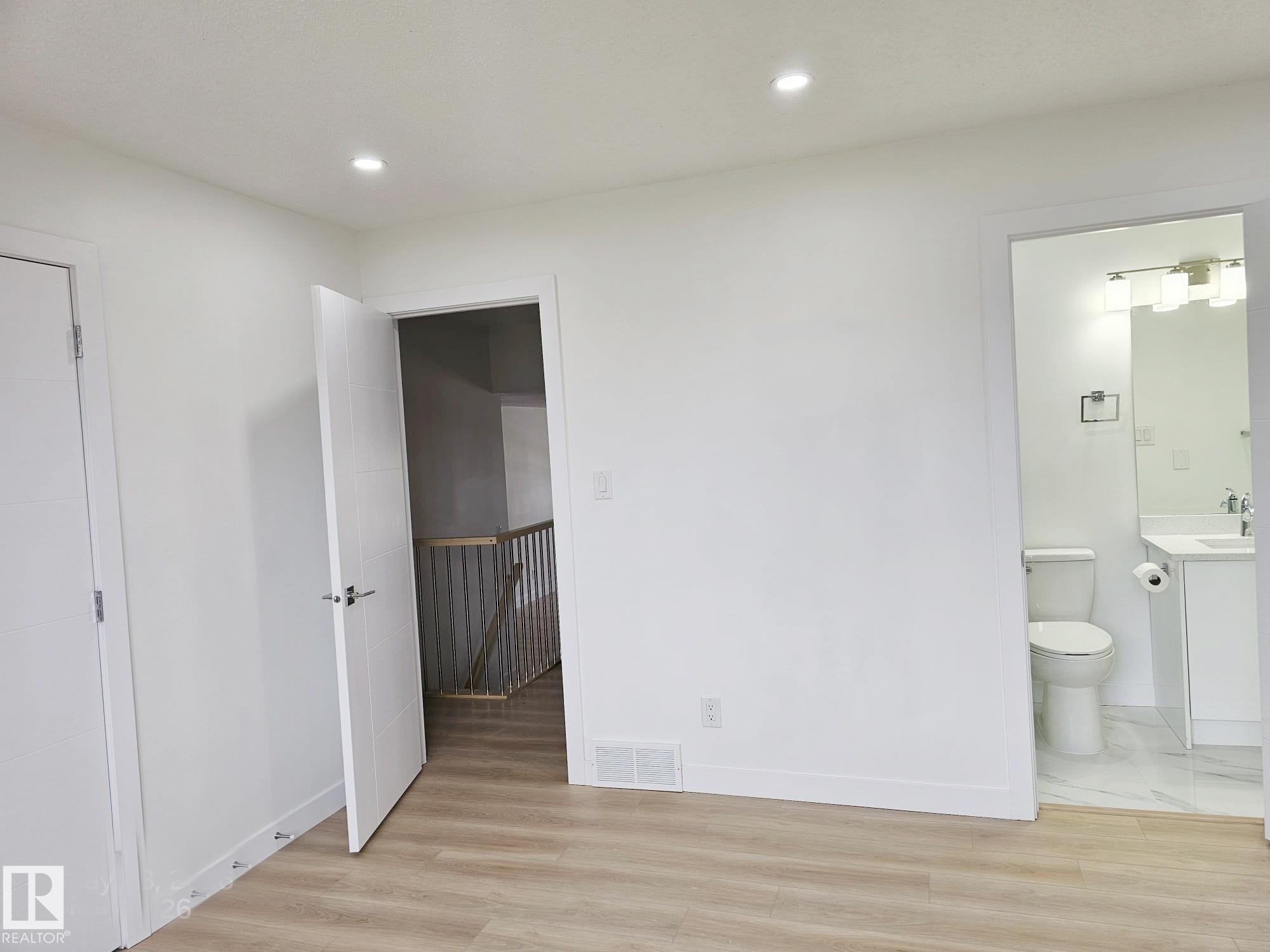 Room featuring wood-finish flooring, recessed ceiling lighting, and crisp white walls - 20 Hunt Road, Edmonton, AB - Indoor Photo Showing Other Room