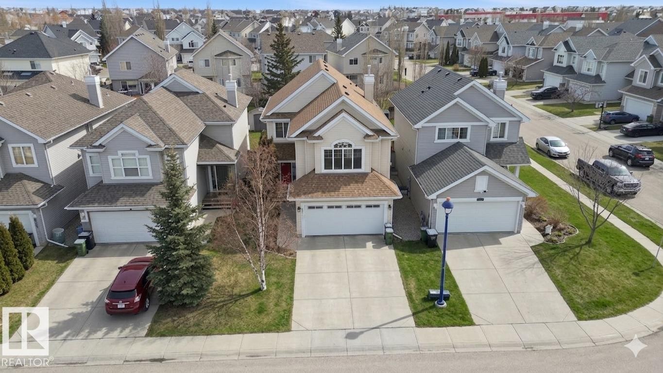 Two-story residence featuring a neutral-toned exterior, an attached two-car garage, and a gabled roofline - 8311 11 Avenue, Edmonton, AB - Outdoor With Facade