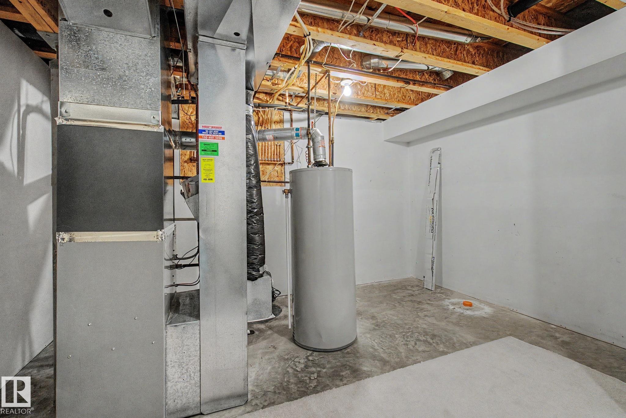 Basement utility area featuring exposed wood ceiling joists and concrete flooring - 8311 11 Avenue, Edmonton, AB