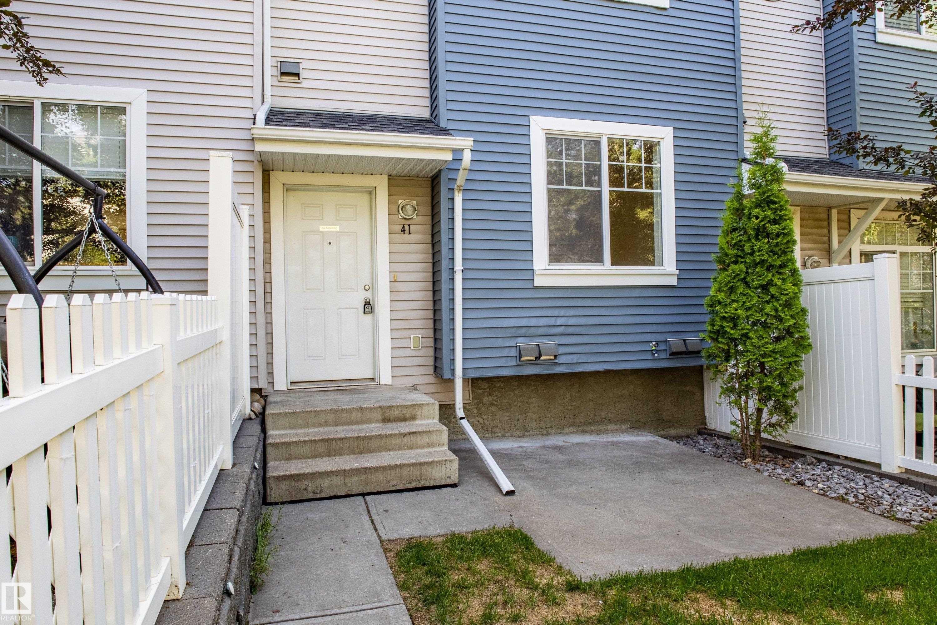 Entrance to property featuring roof with shingles and a patio - 41 8304 11 Avenue, Edmonton, AB - Outdoor