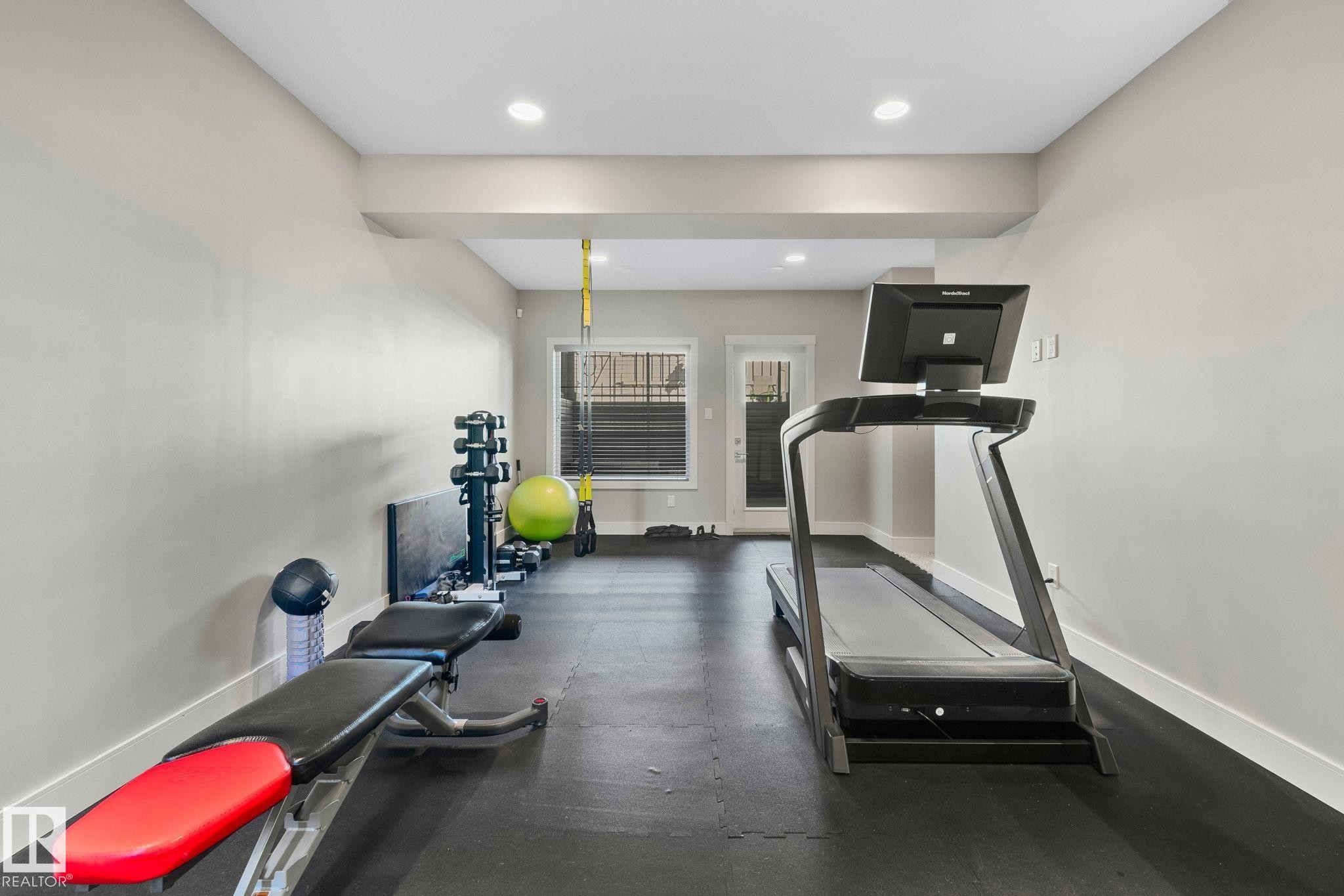 Dedicated fitness area featuring recessed lighting, light gray walls, and dark flooring - 67 Enchanted Way Nw, St. Albert, AB - Indoor Photo Showing Gym Room