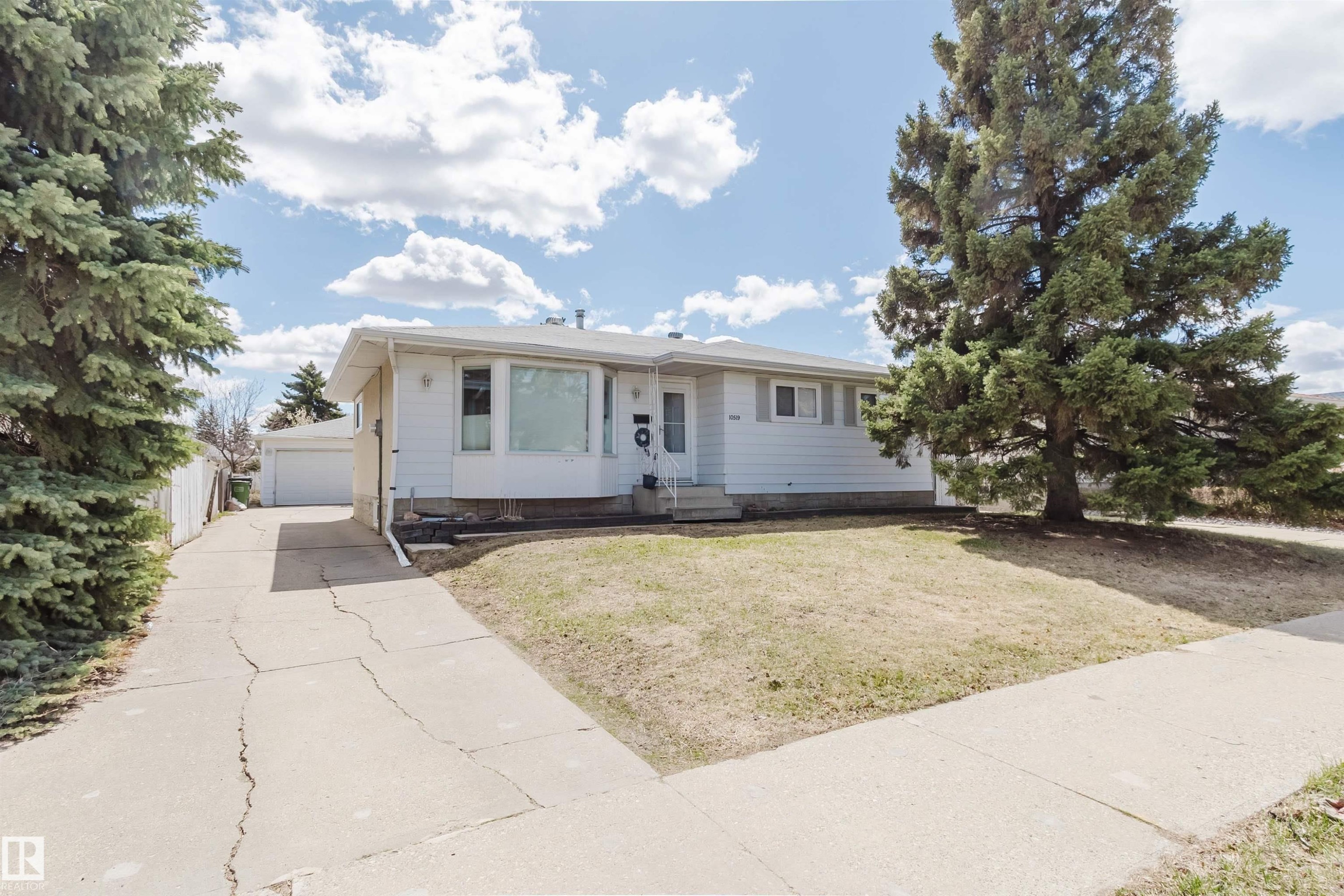 Single-story residence featuring white siding and a prominent front picture window - 10519 36A Avenue, Edmonton, AB - Outdoor With Facade