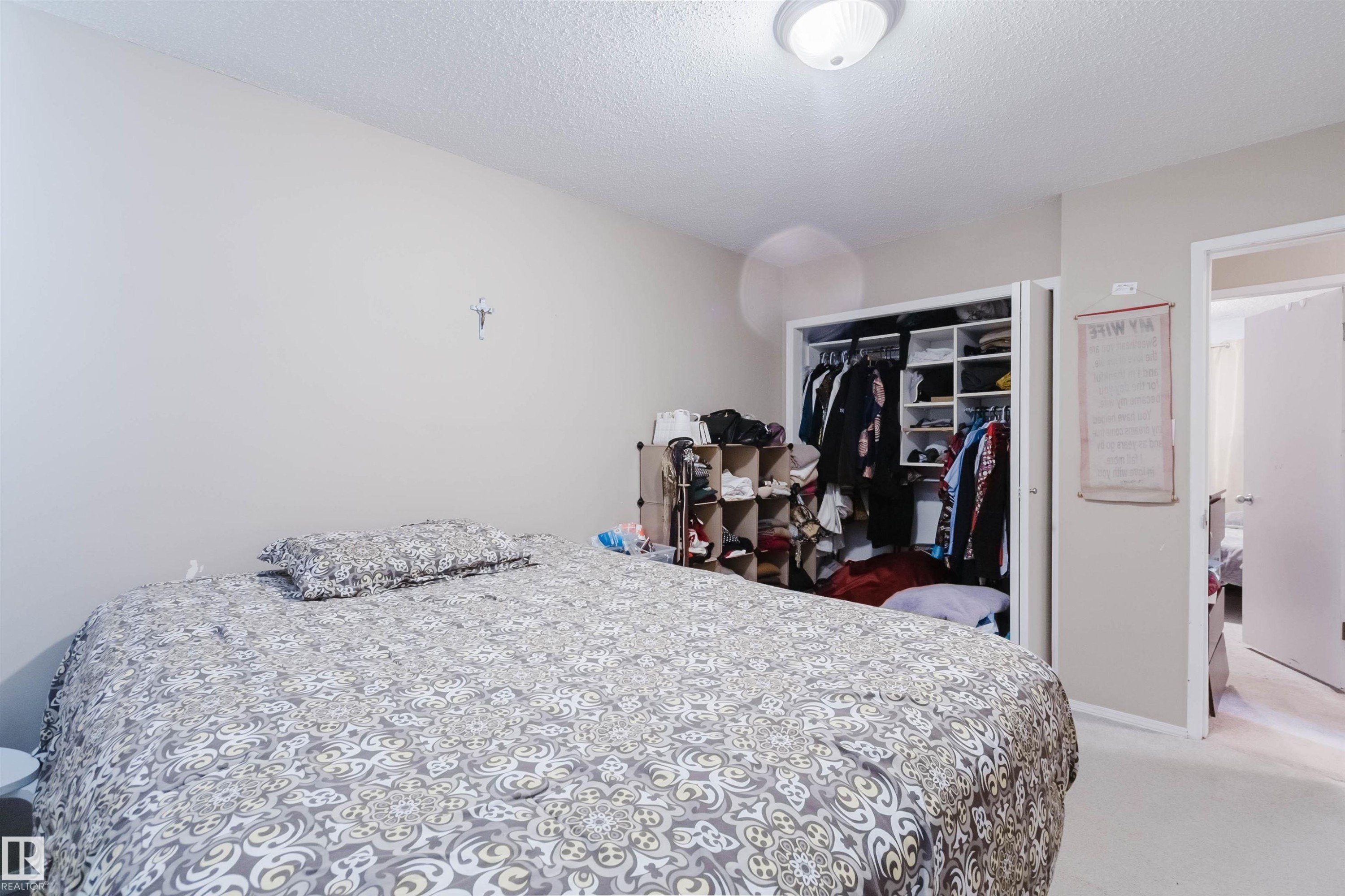 Bedroom featuring light beige walls and textured white ceiling - 10519 36A Avenue, Edmonton, AB - Indoor Photo Showing Bedroom