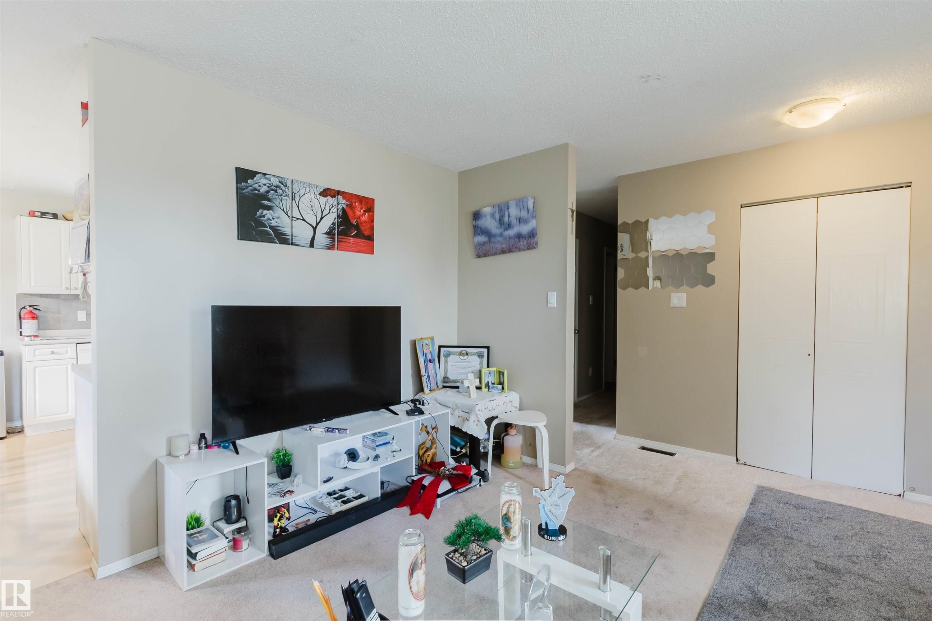 Living area featuring wall-to-wall carpeting and a ceiling-mounted light fixture - 10519 36A Avenue, Edmonton, AB - Indoor