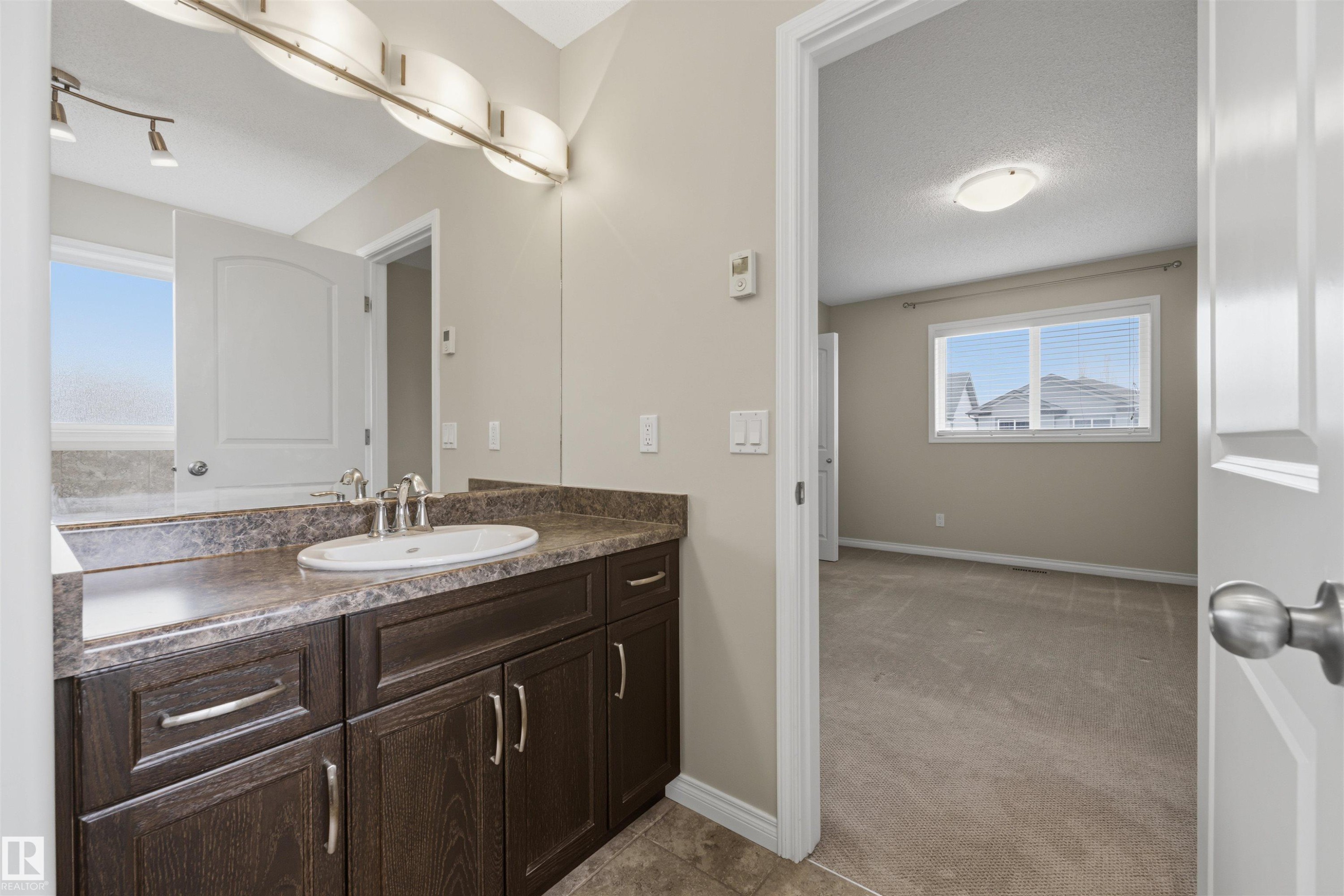 Ensuite 4-PC bath off the primary bedroom with in-floor heating. - 20813 96A Avenue, Edmonton, AB - Indoor Photo Showing Bathroom