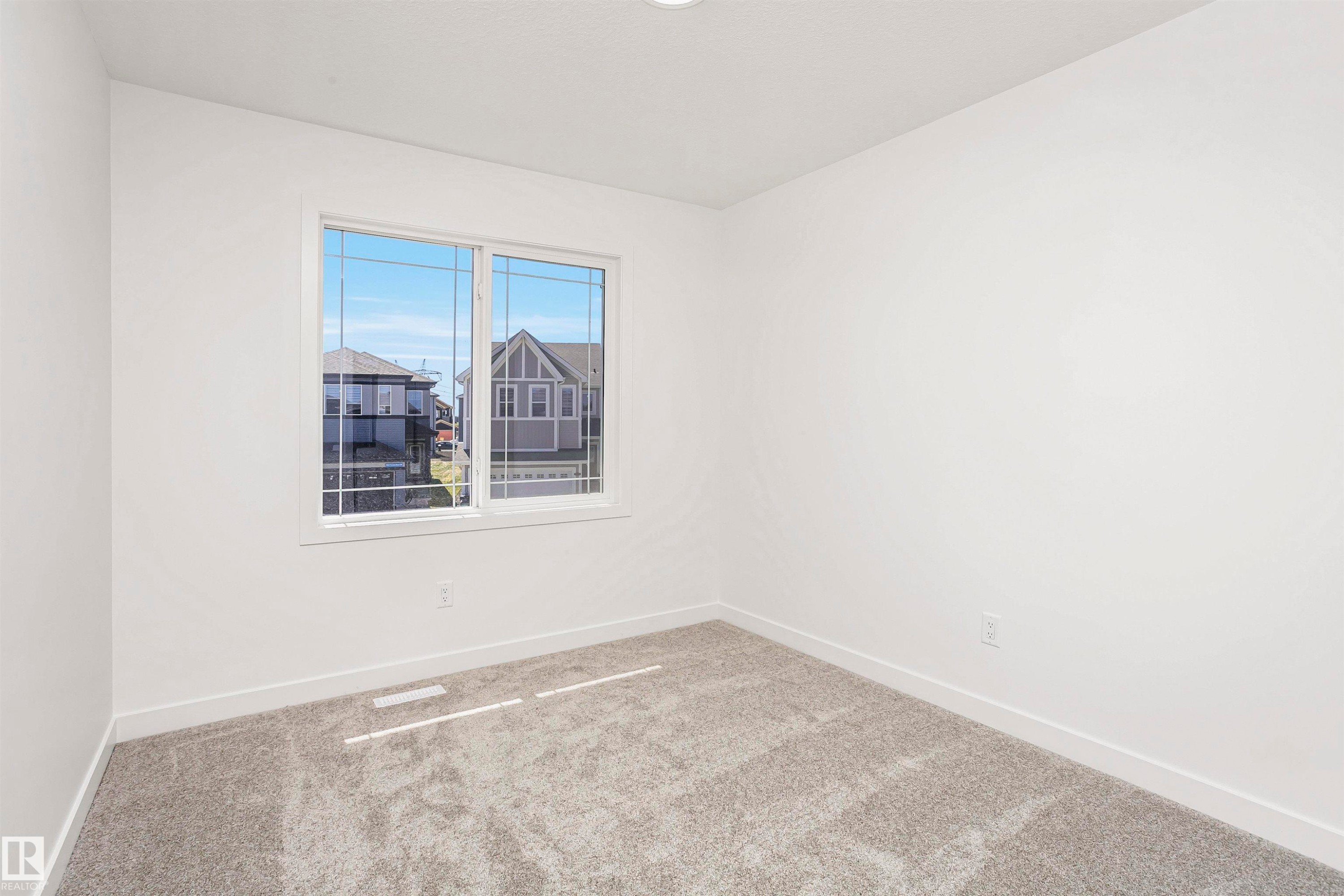 Bright room featuring a multi-pane window, neutral carpet flooring, white walls, and recessed lighting - 9552 Carson Bend Bend, Edmonton, AB - Indoor Photo Showing Other Room