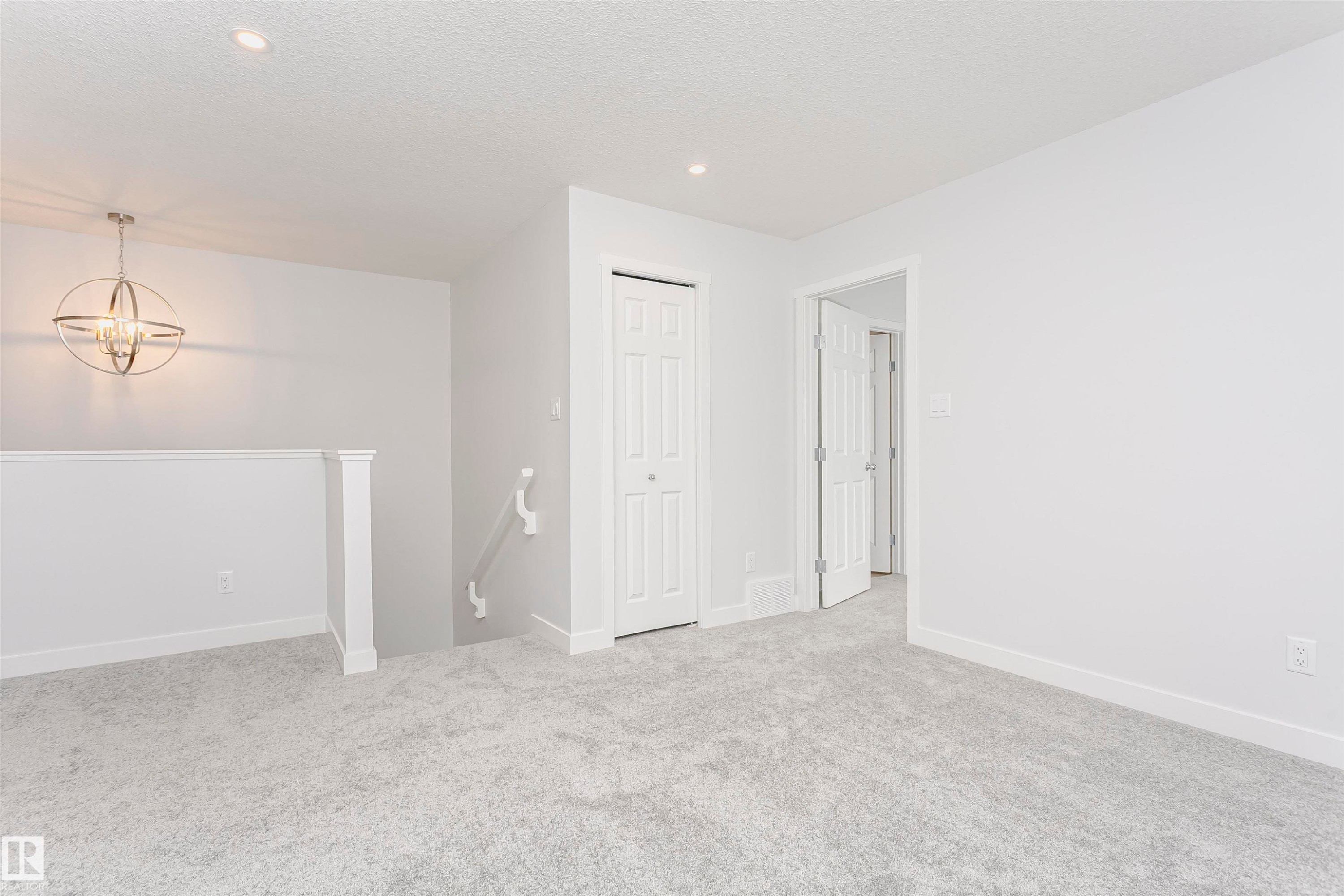 Open loft area featuring gray carpeting and white trim - 9564 Carson Bend Bend, Edmonton, AB - Indoor Photo Showing Other Room