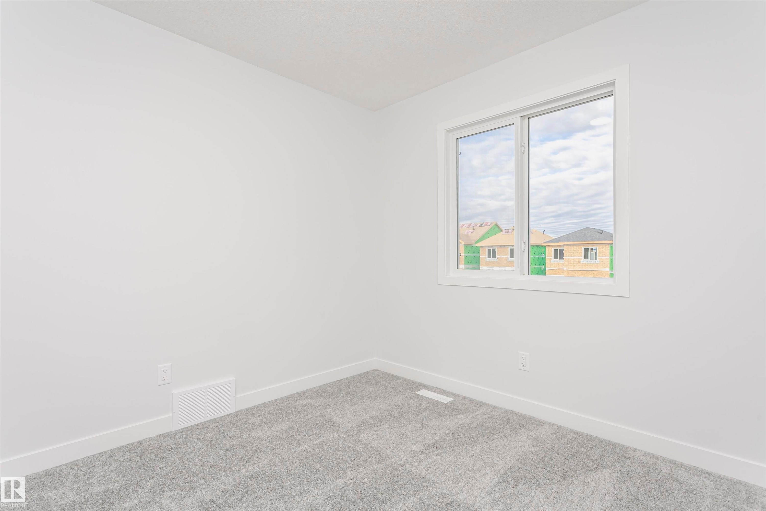 Light-filled interior space with a window featuring white trim - 9564 Carson Bend Bend, Edmonton, AB - Indoor Photo Showing Other Room