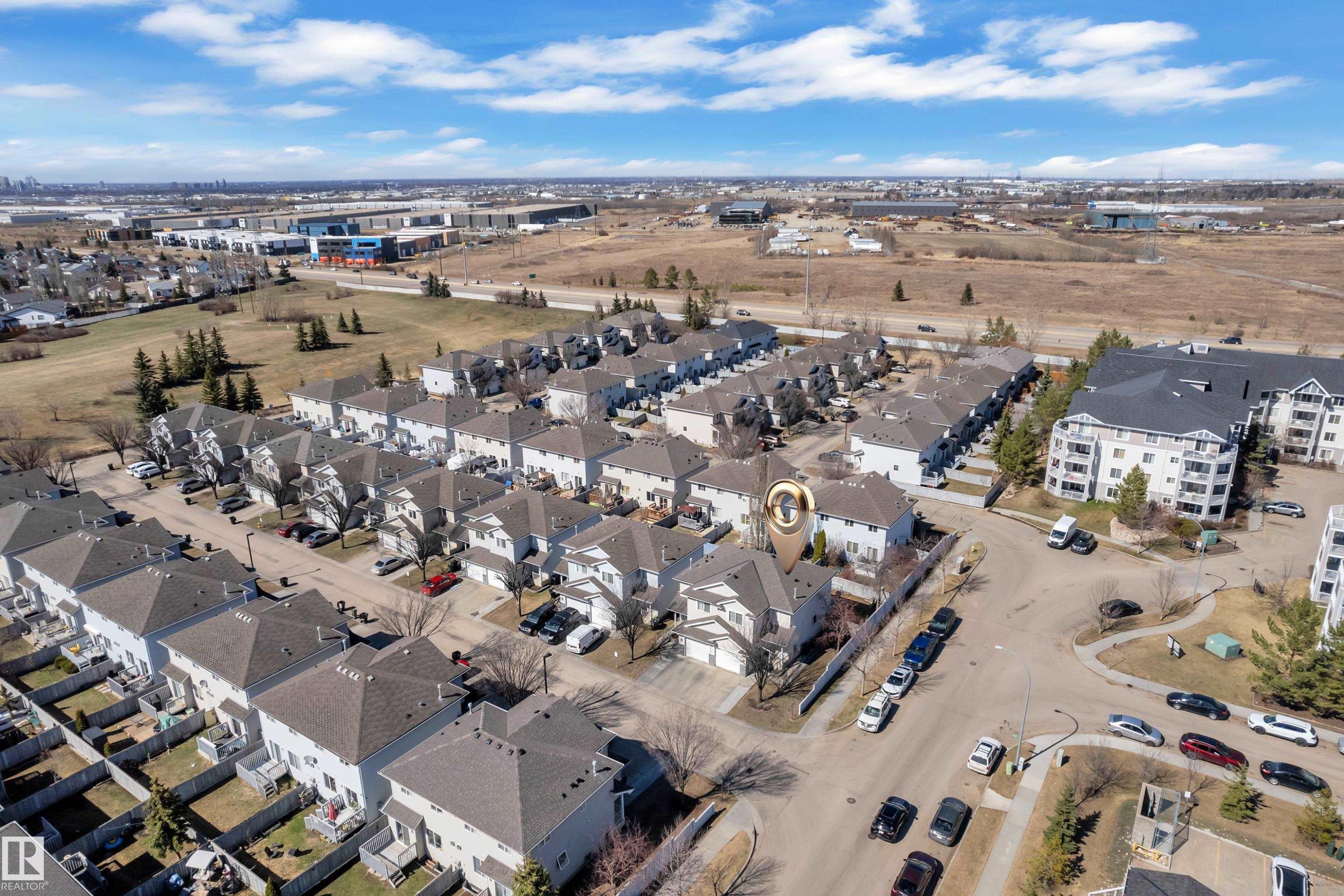 Residential neighborhood featuring detached and attached multi-story homes with individual driveways and private yards - #64 4350 23 St Nw, Edmonton, AB - Outdoor With View