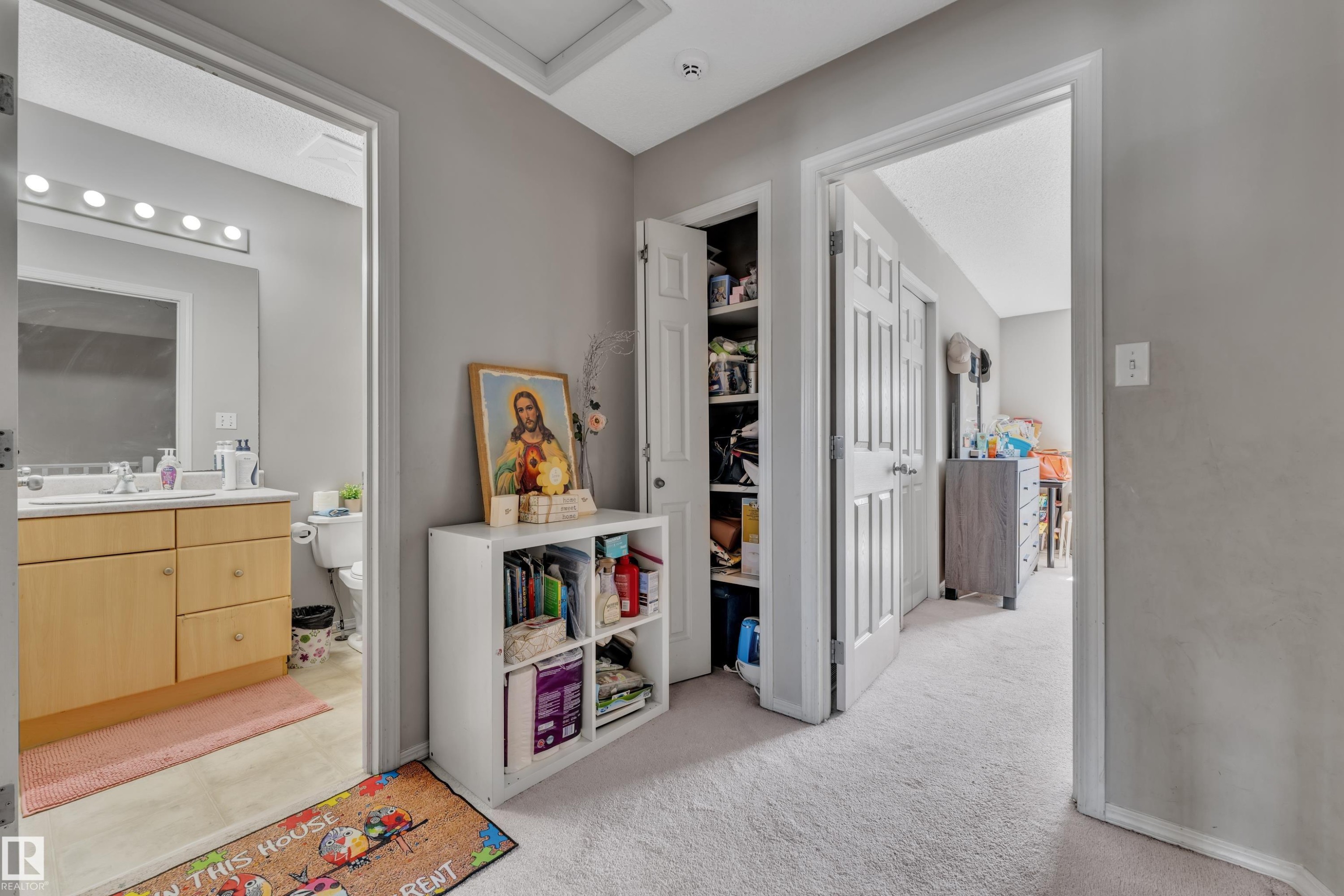 Hallway with light gray walls and plush carpet flooring - #64 4350 23 St Nw, Edmonton, AB - Indoor