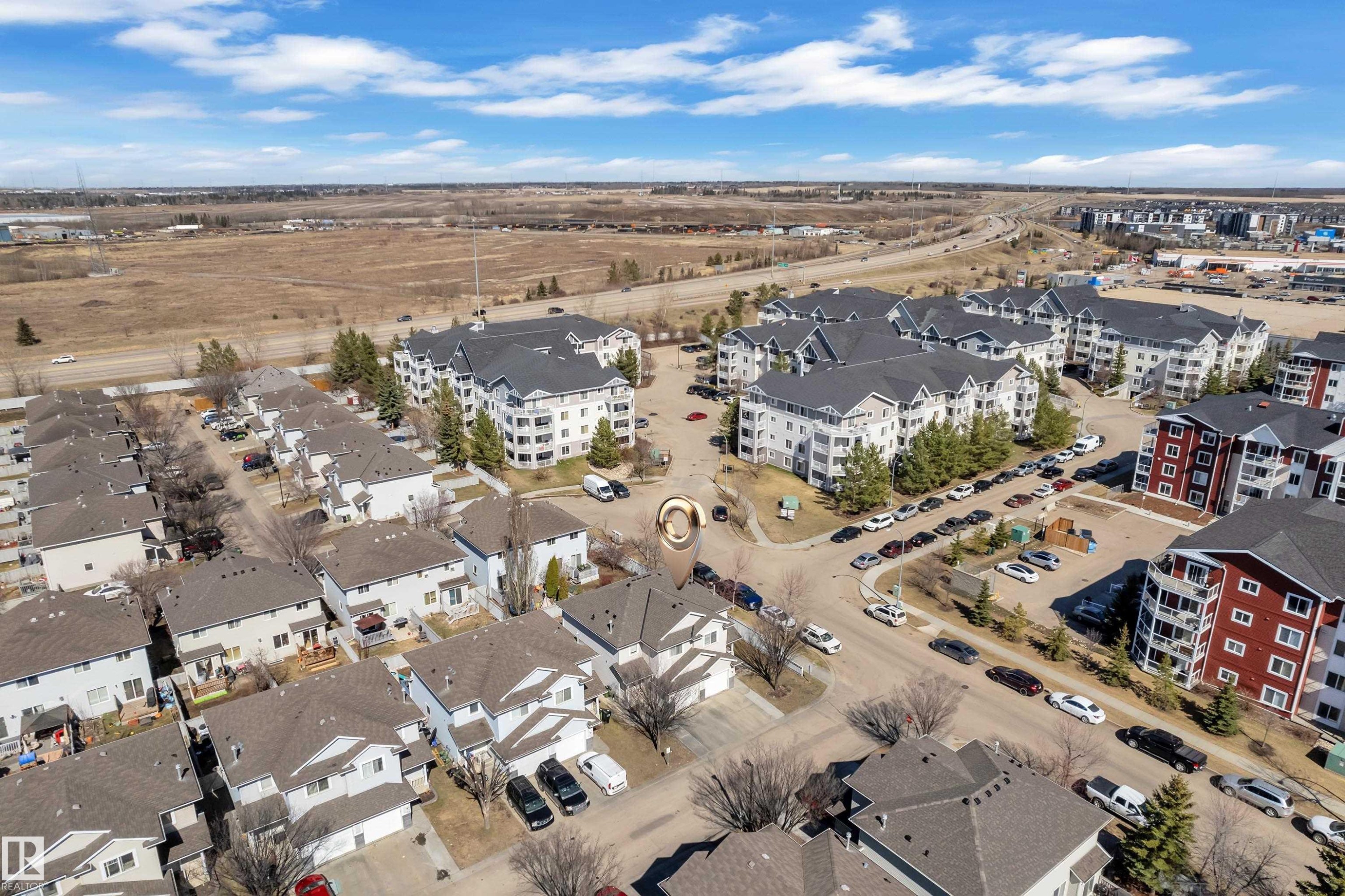 Aerial depiction of a residential community featuring townhomes and multi-story apartment buildings - #64 4350 23 St Nw, Edmonton, AB - Outdoor With View