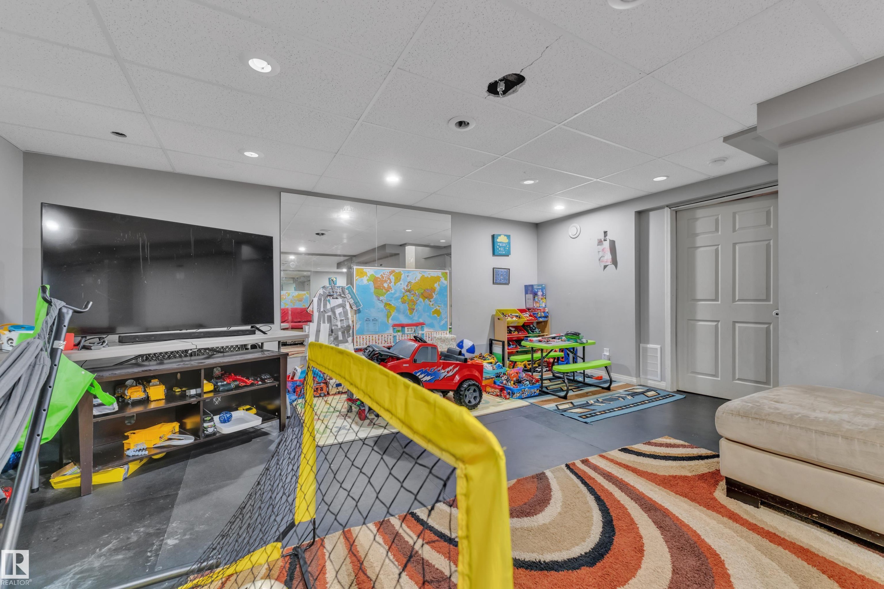 Finished room featuring recessed lighting, a drop ceiling, and light gray painted walls - #64 4350 23 St Nw, Edmonton, AB - Indoor