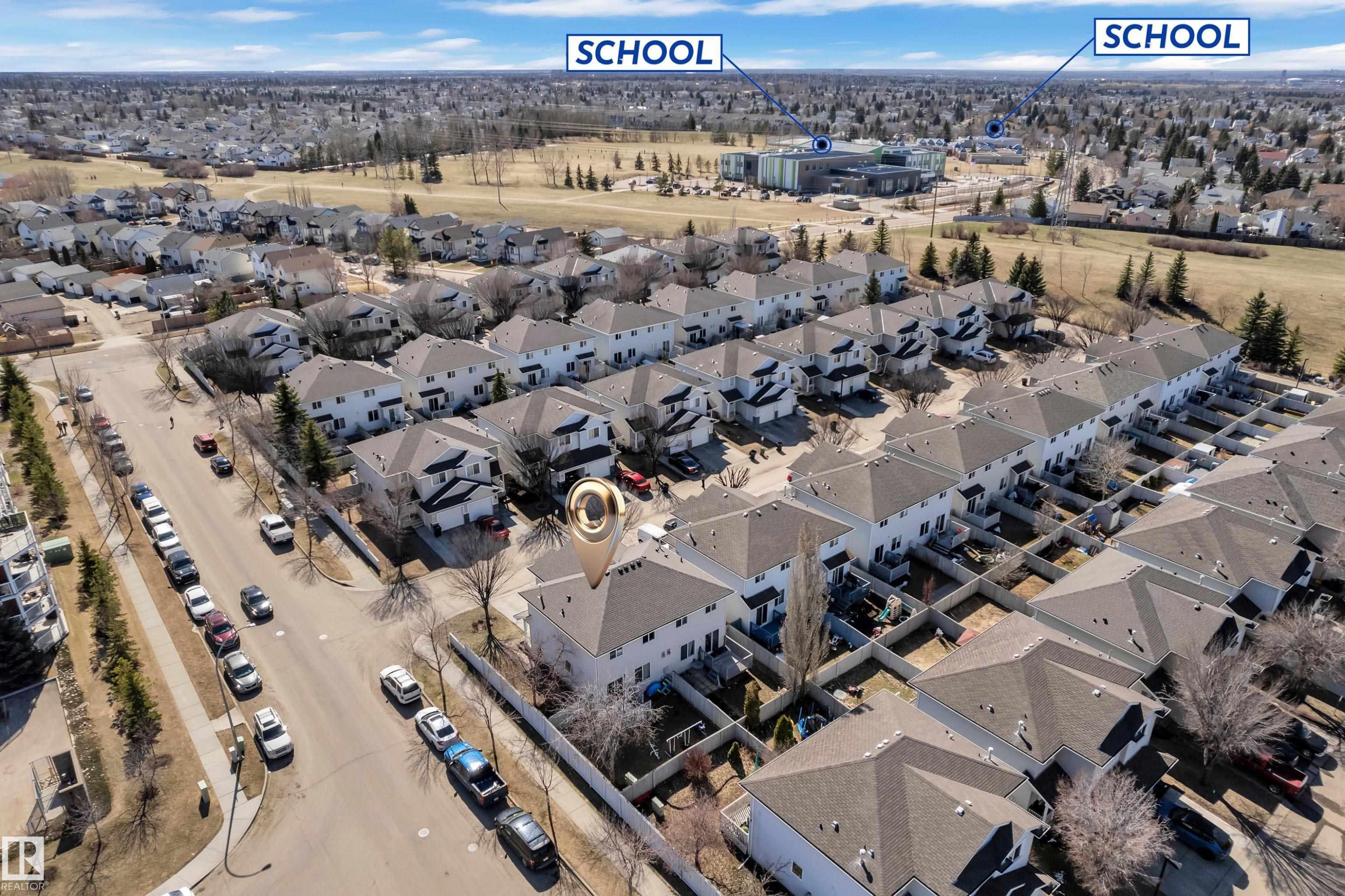 Aerial perspective showcasing a residential neighborhood with detached homes and townhouses - #64 4350 23 St Nw, Edmonton, AB - Outdoor With View