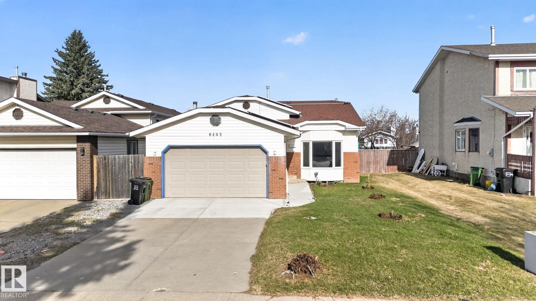 Single-story residence featuring a two-car garage, concrete driveway, and a bay window - 8403 190 Street, Edmonton, AB - Outdoor With Facade