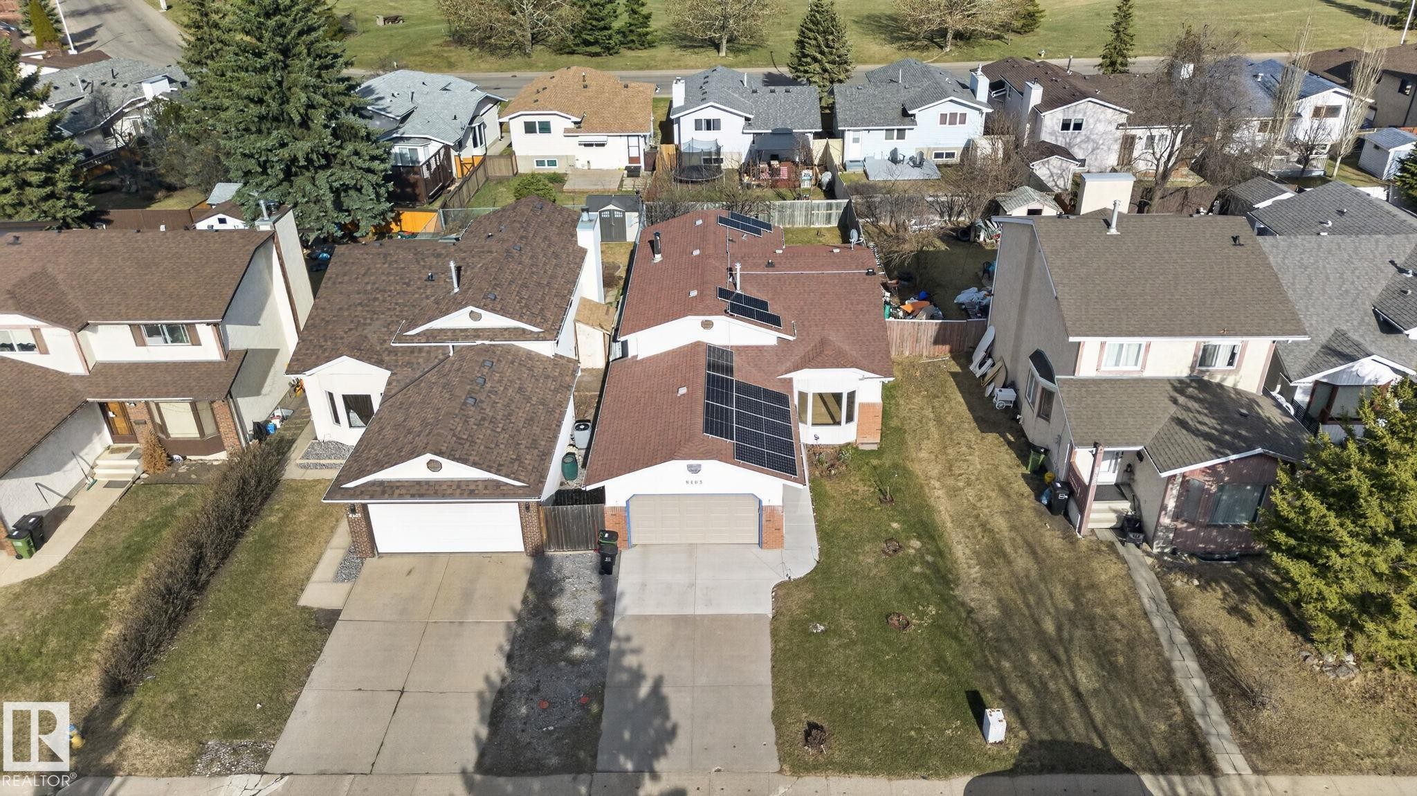 Aerial perspective showcasing a residential property with a detached garage and a paved driveway - 8403 190 Street, Edmonton, AB - Outdoor