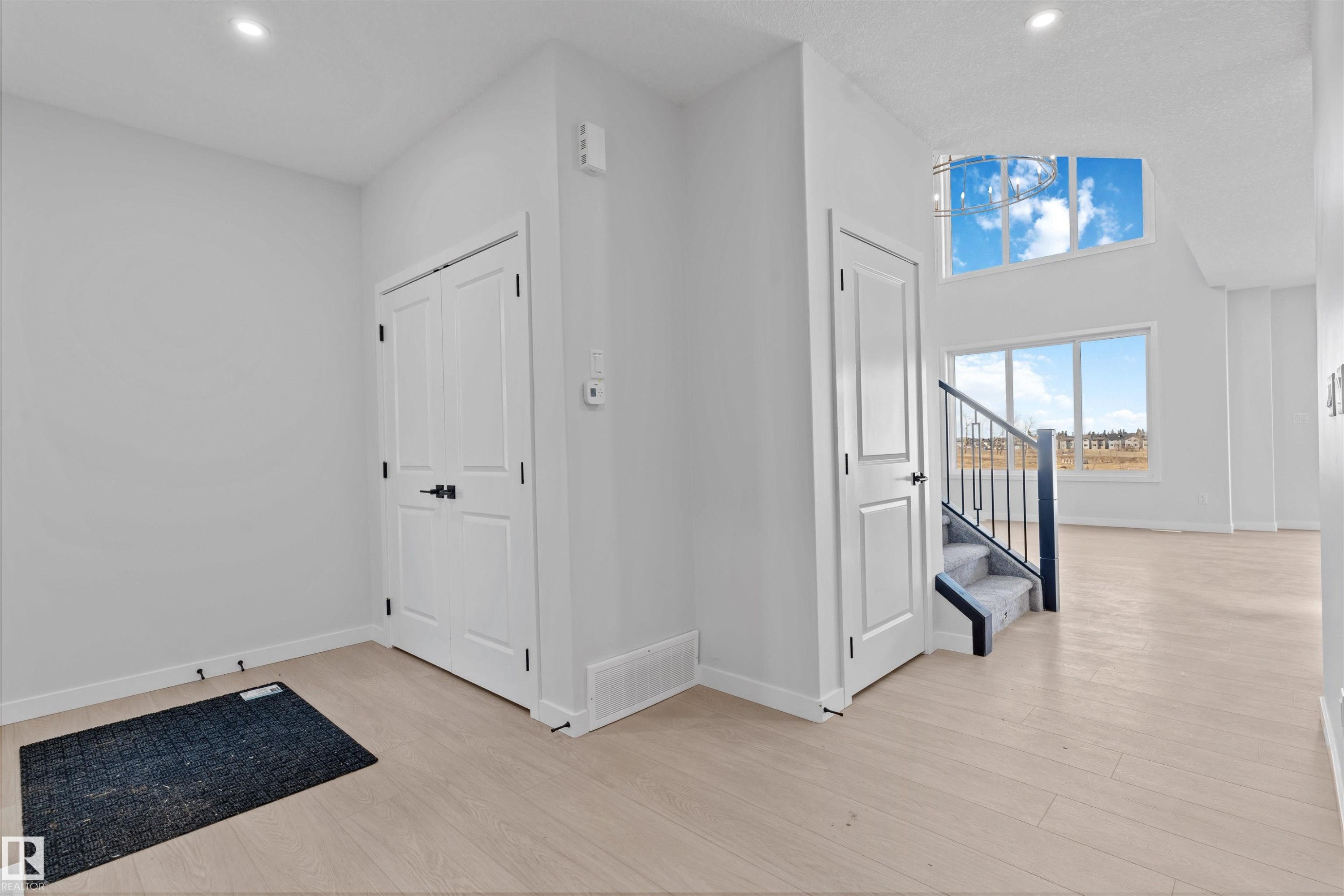 Bright entry foyer featuring light wood-finish flooring, recessed lighting, and a double-door closet - 1849 Crossbill Loop Nw, Edmonton, AB - Indoor Photo Showing Other Room
