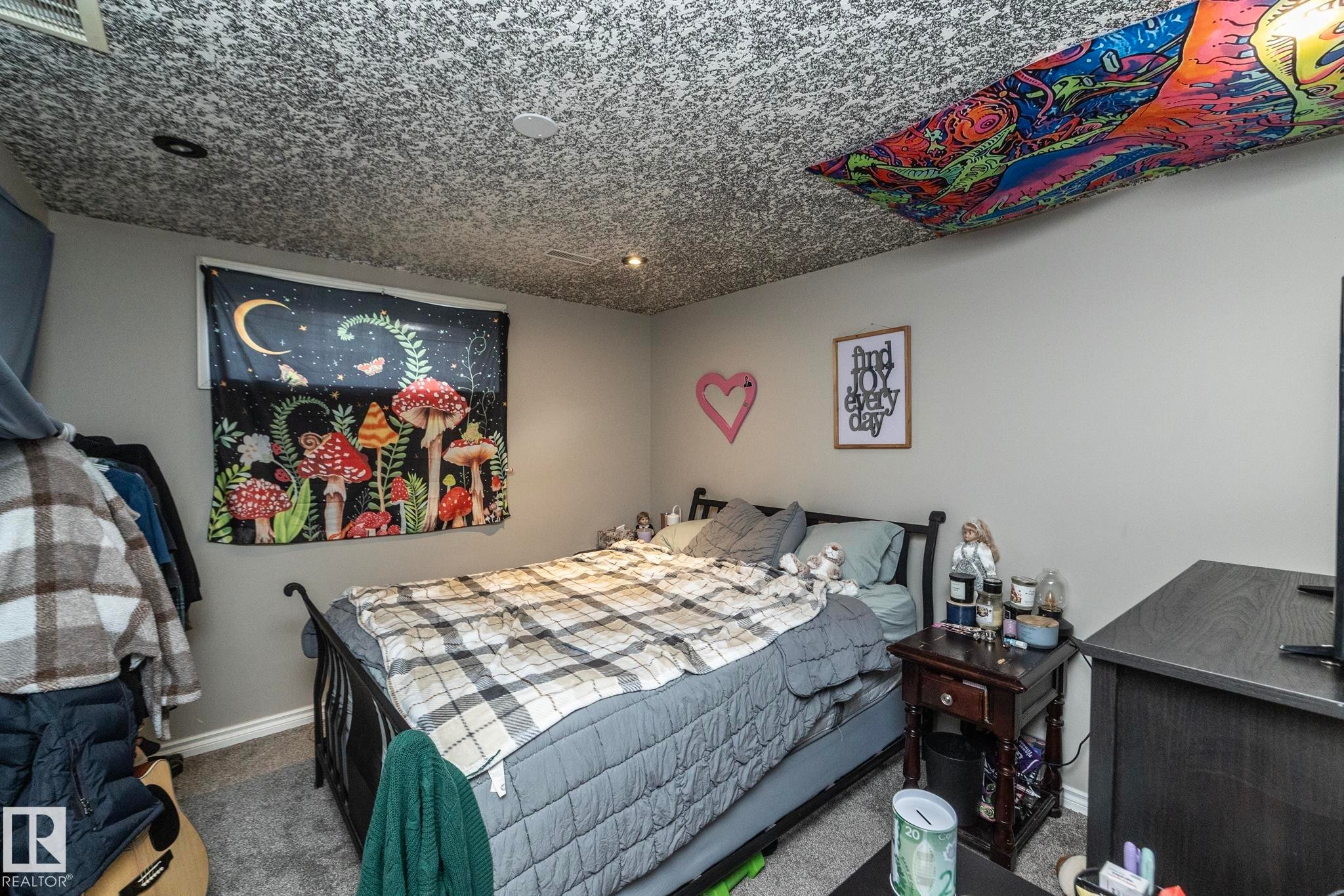 Bedroom featuring light gray wall paint, gray carpet flooring, and a textured ceiling with recessed lighting - 65 Birchmont Drive, Leduc, AB - Indoor Photo Showing Bedroom
