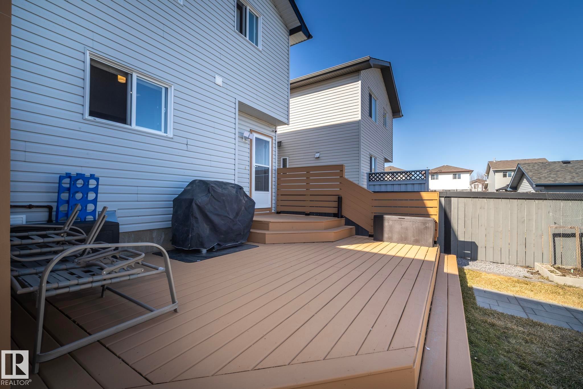 Multi-level deck featuring composite decking, privacy screen, and direct access to the interior - 65 Birchmont Drive, Leduc, AB - Outdoor With Deck Patio Veranda With Exterior