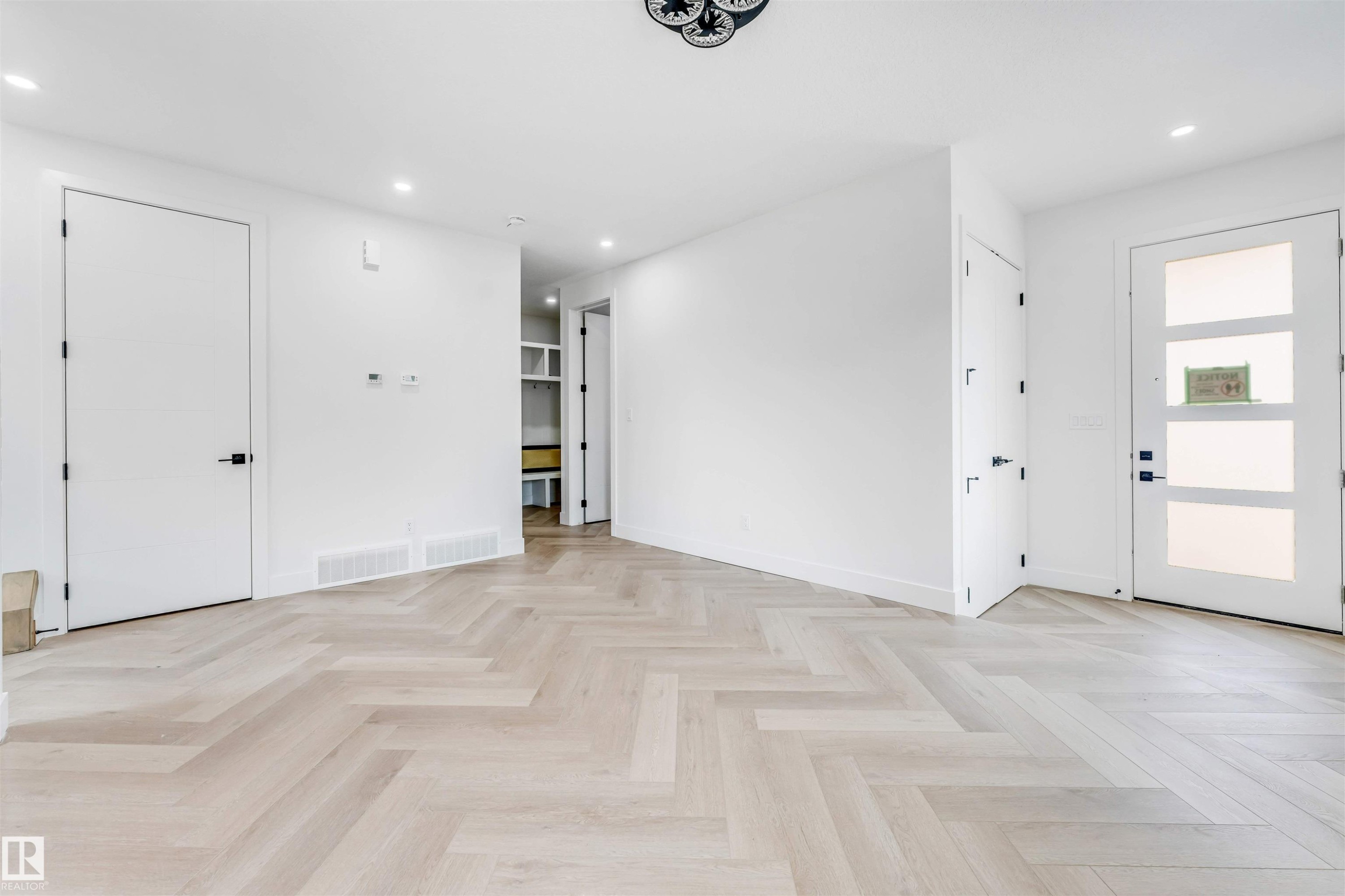 Light wood-finish flooring in a herringbone pattern - 4006 35 St, Beaumont, AB - Indoor Photo Showing Other Room