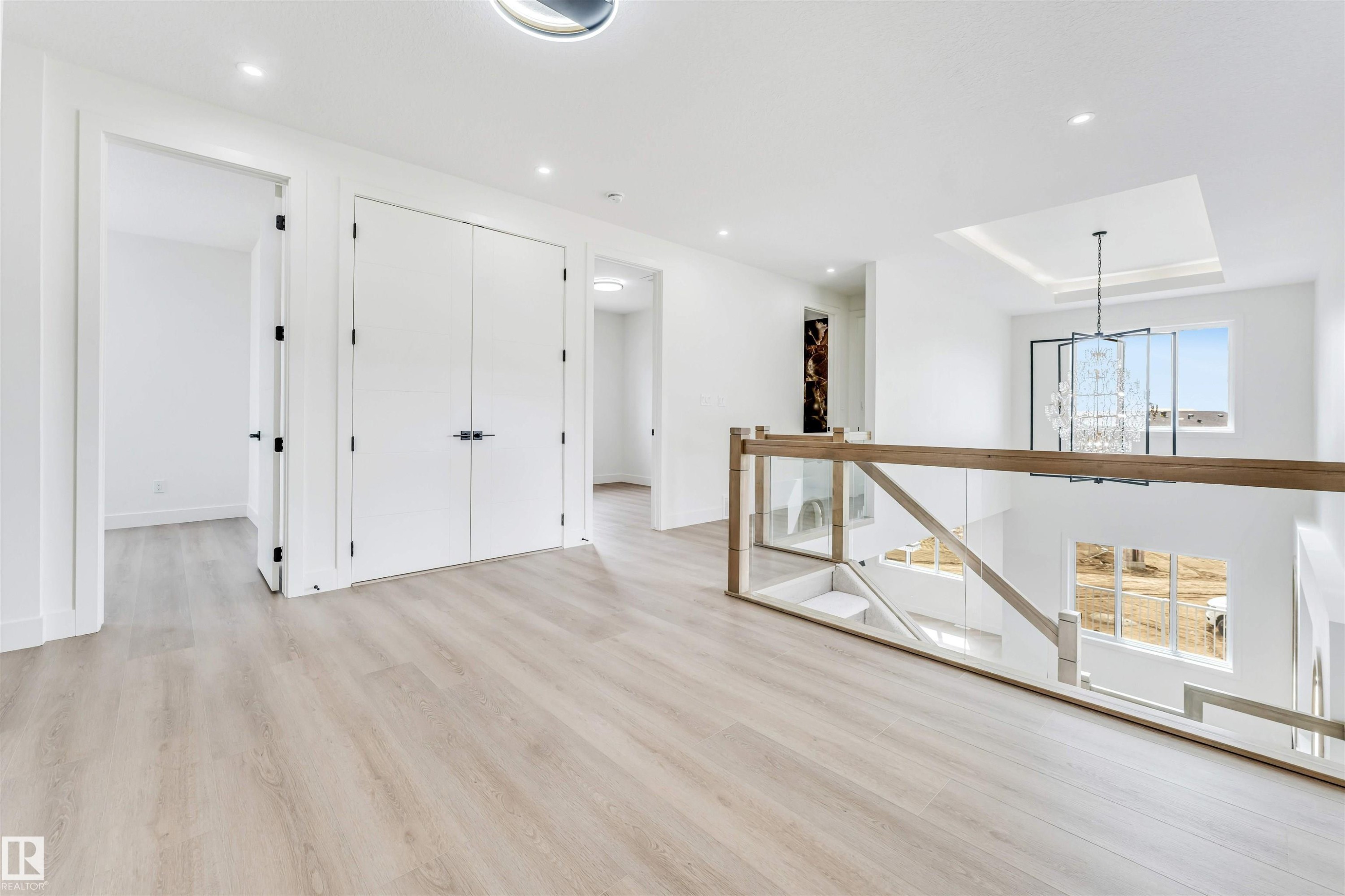 Spacious upper landing featuring light wood-finish flooring, white walls, and recessed lighting - 4006 35 St, Beaumont, AB - Indoor Photo Showing Other Room