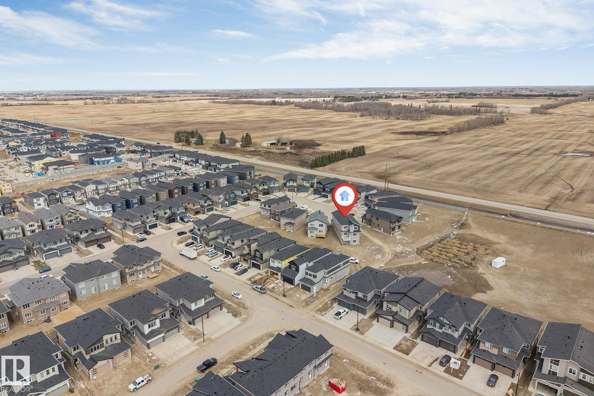 Aerial view of a residential development featuring single-family homes and duplexes - 4006 35 St, Beaumont, AB - Outdoor With View
