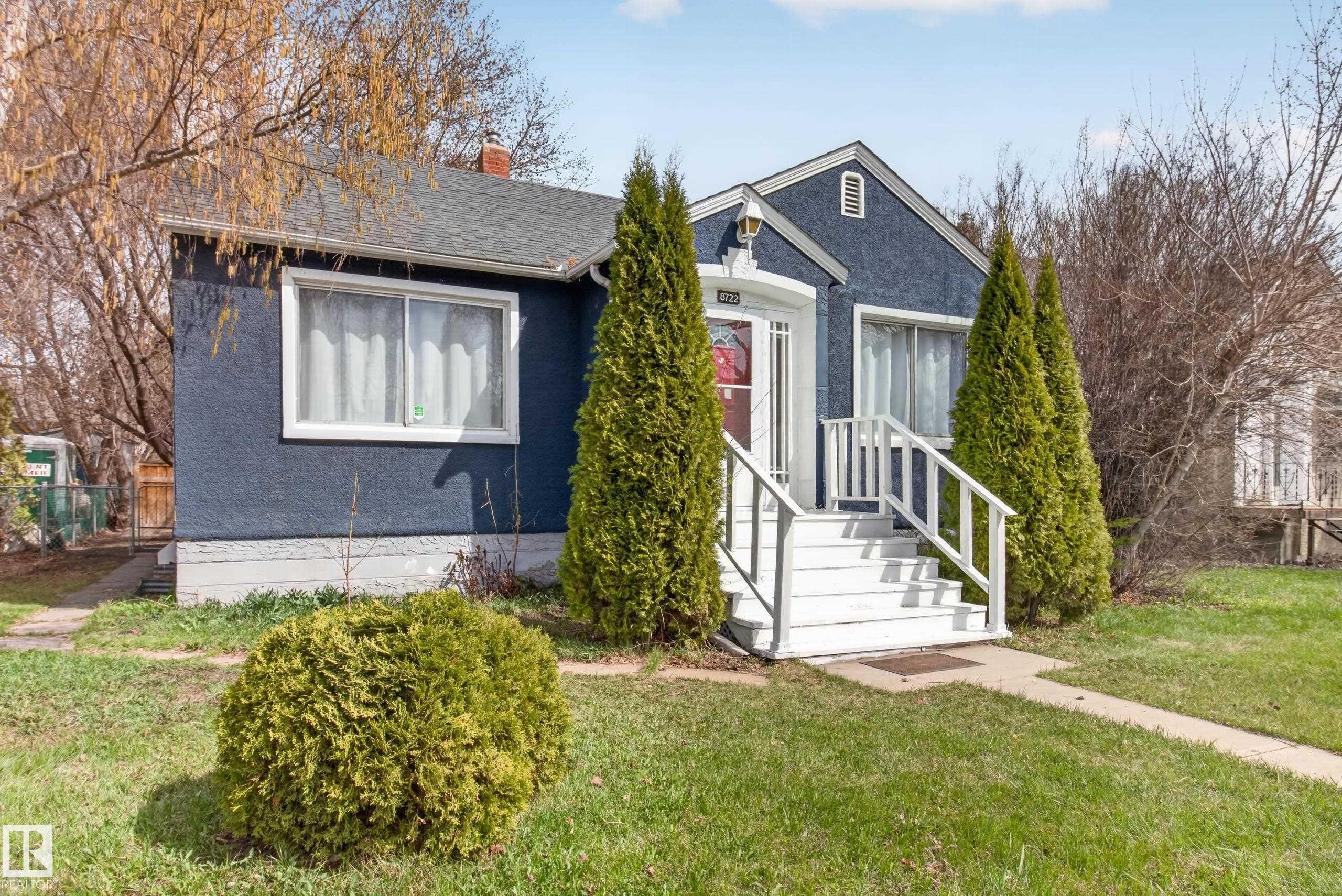 Charming single-story residence with a blue stucco exterior and white trim - 8722 112 Avenue, Edmonton, AB - Outdoor