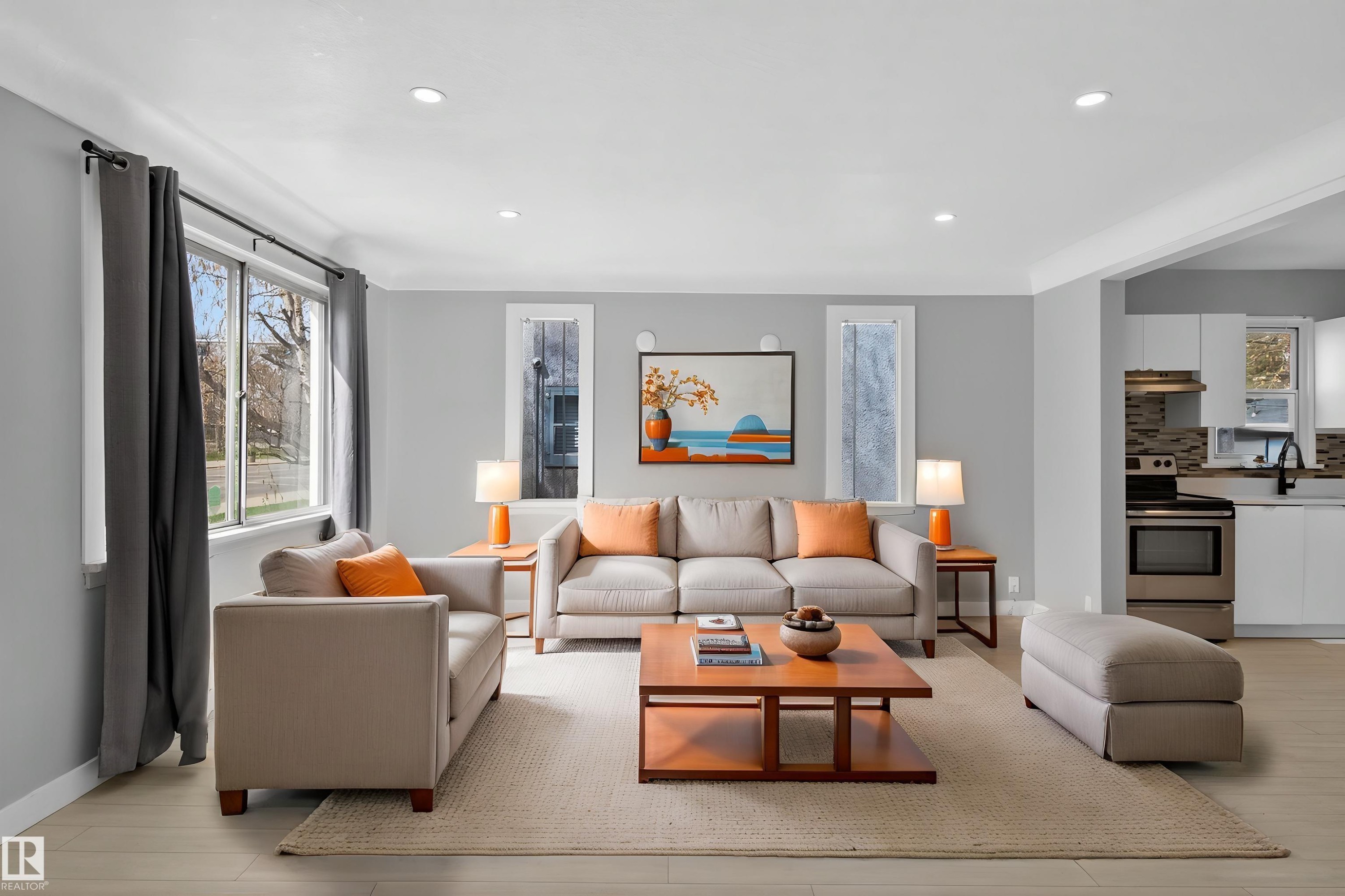 Open-concept living area featuring light wood-finish flooring, recessed lighting, and crisp white trim - 8722 112 Avenue, Edmonton, AB - Indoor Photo Showing Living Room