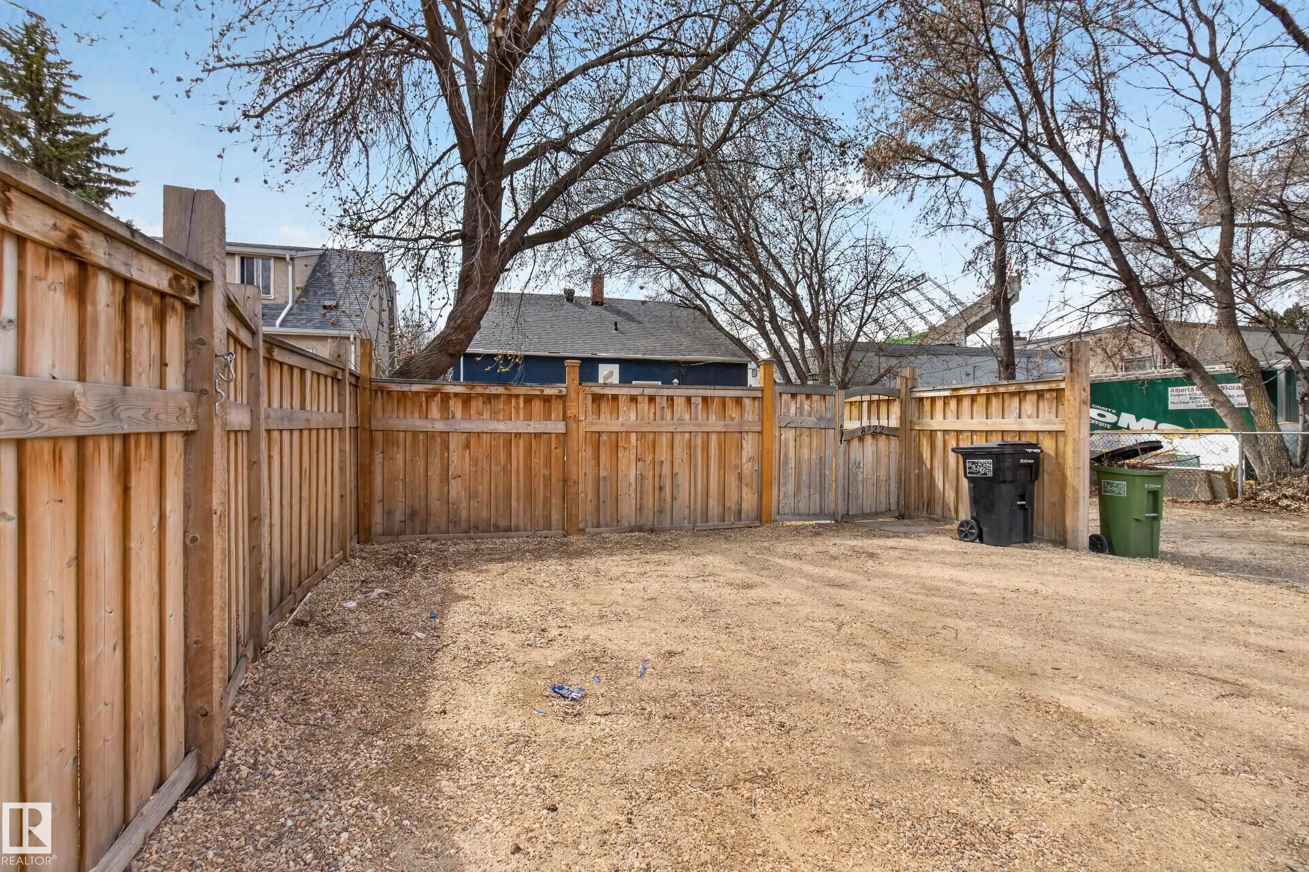 Enclosed yard area featuring natural wood privacy fencing - 8722 112 Avenue, Edmonton, AB - Outdoor