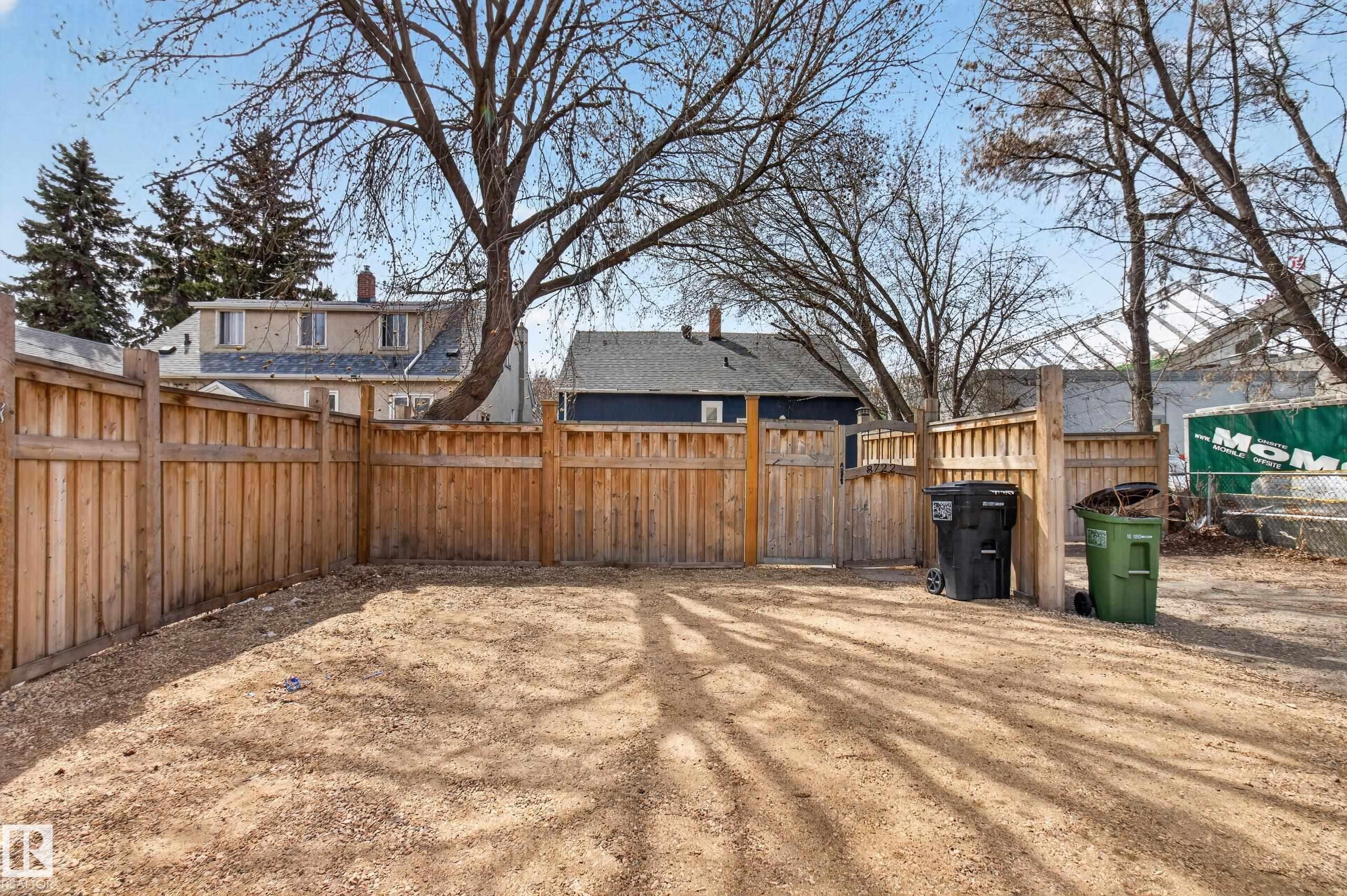 Enclosed backyard featuring a privacy fence, a gate, and a gravel-covered surface - 8722 112 Avenue, Edmonton, AB - Outdoor