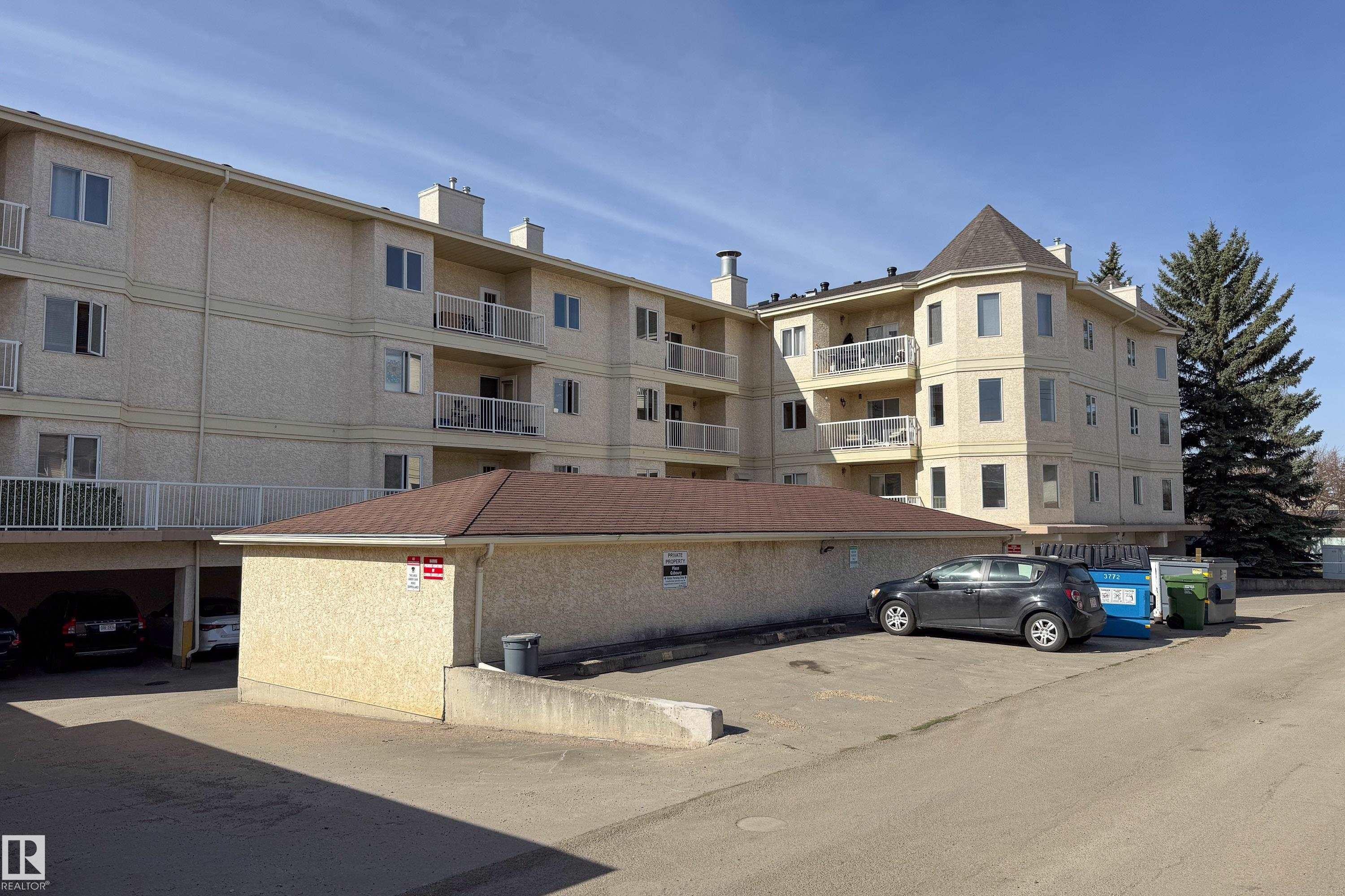 Multi-story building featuring a stucco exterior and a conical turret roof accent - 302 9138 83 Avenue, Edmonton, AB - Outdoor With Balcony