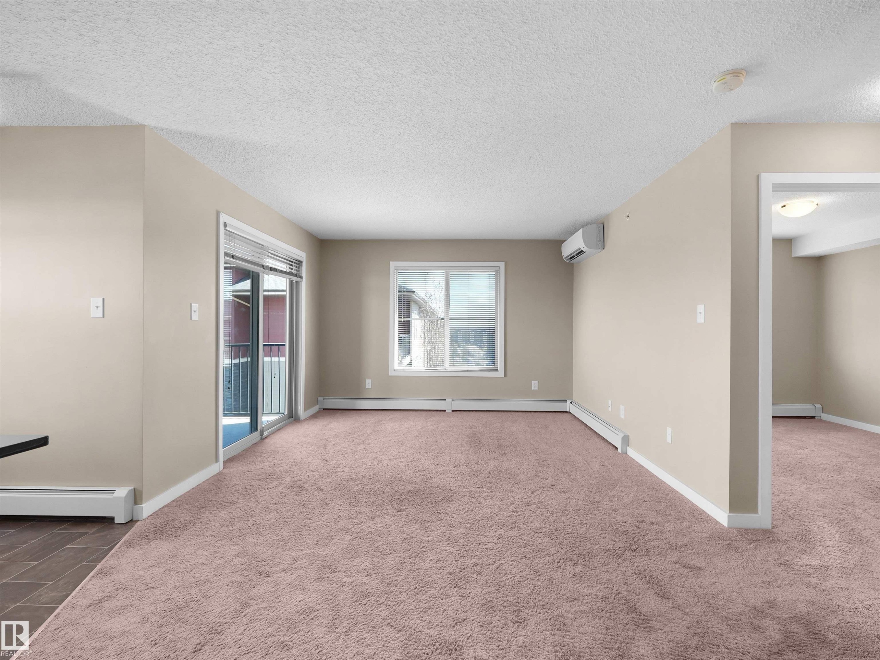 Spacious entryway featuring light-toned tile flooring and recessed lighting - 417 1060 Mcconachie Boulevard, Edmonton, AB - Indoor Photo Showing Other Room